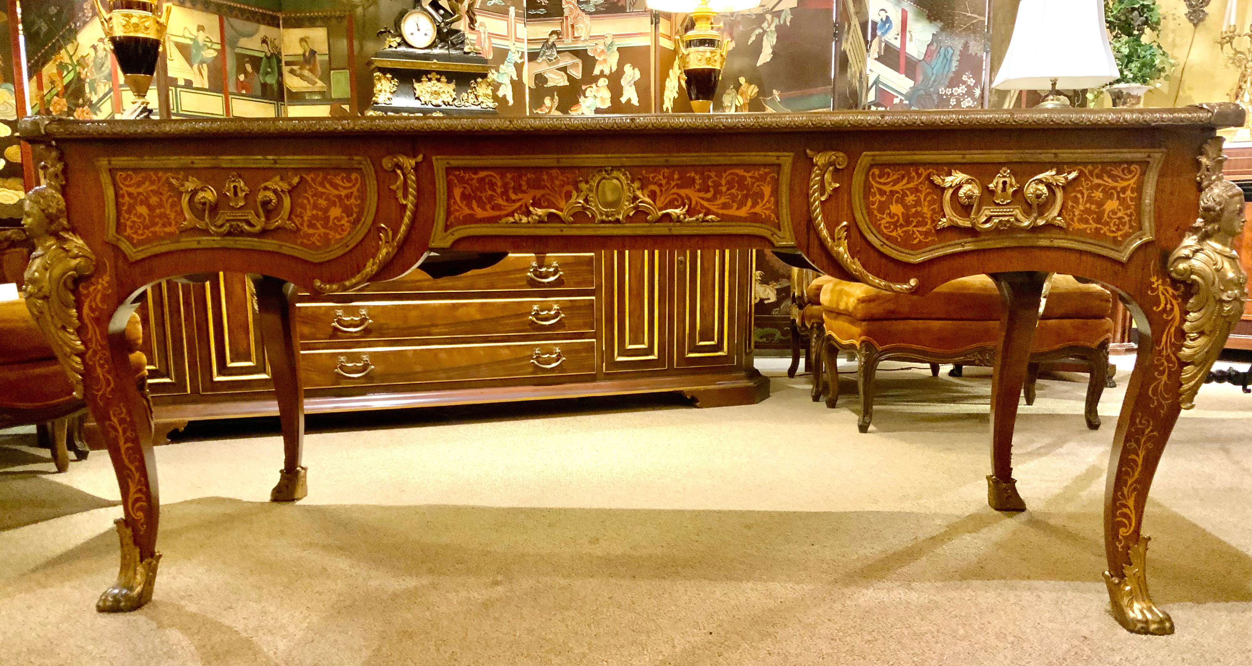 This exquisite desk is very well made with beech wood and oak with
Kingwood marquetry decorative motifs. Gilt bronze mounts decorate 
The edge and gilt masks embellish each corner. The rectangular top
Is black with gilt embossed edge. It has
