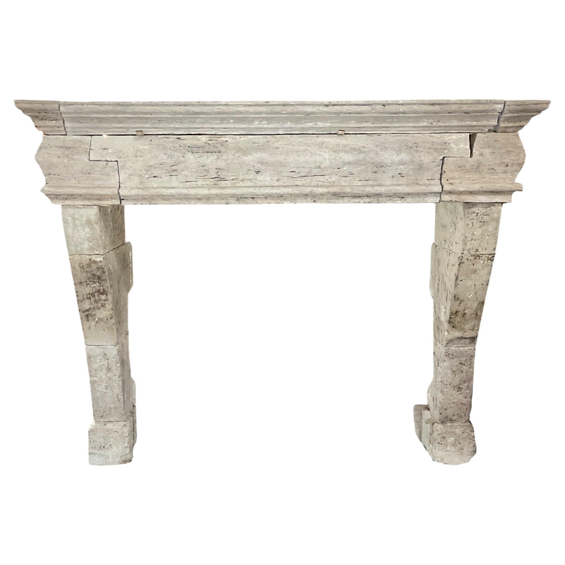 This authentic French Burgundy Limestone Mantel is a beautiful antique piece from the 1750s, featuring a Louis XVI-style design. Crafted from burgundy limestone, it adds a touch of elegance and history to any space. Expertly handmade in France, it's