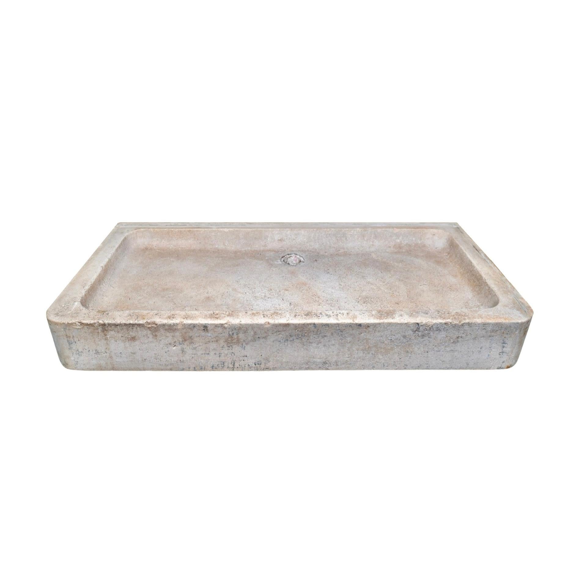 Expertly crafted from luxurious burgundy limestone, this 18th-century French sink boasts a low-line style and spacious rectangular shape. The pre-drilled hole at the center top allows for efficient drainage, making it a practical as well as stunning