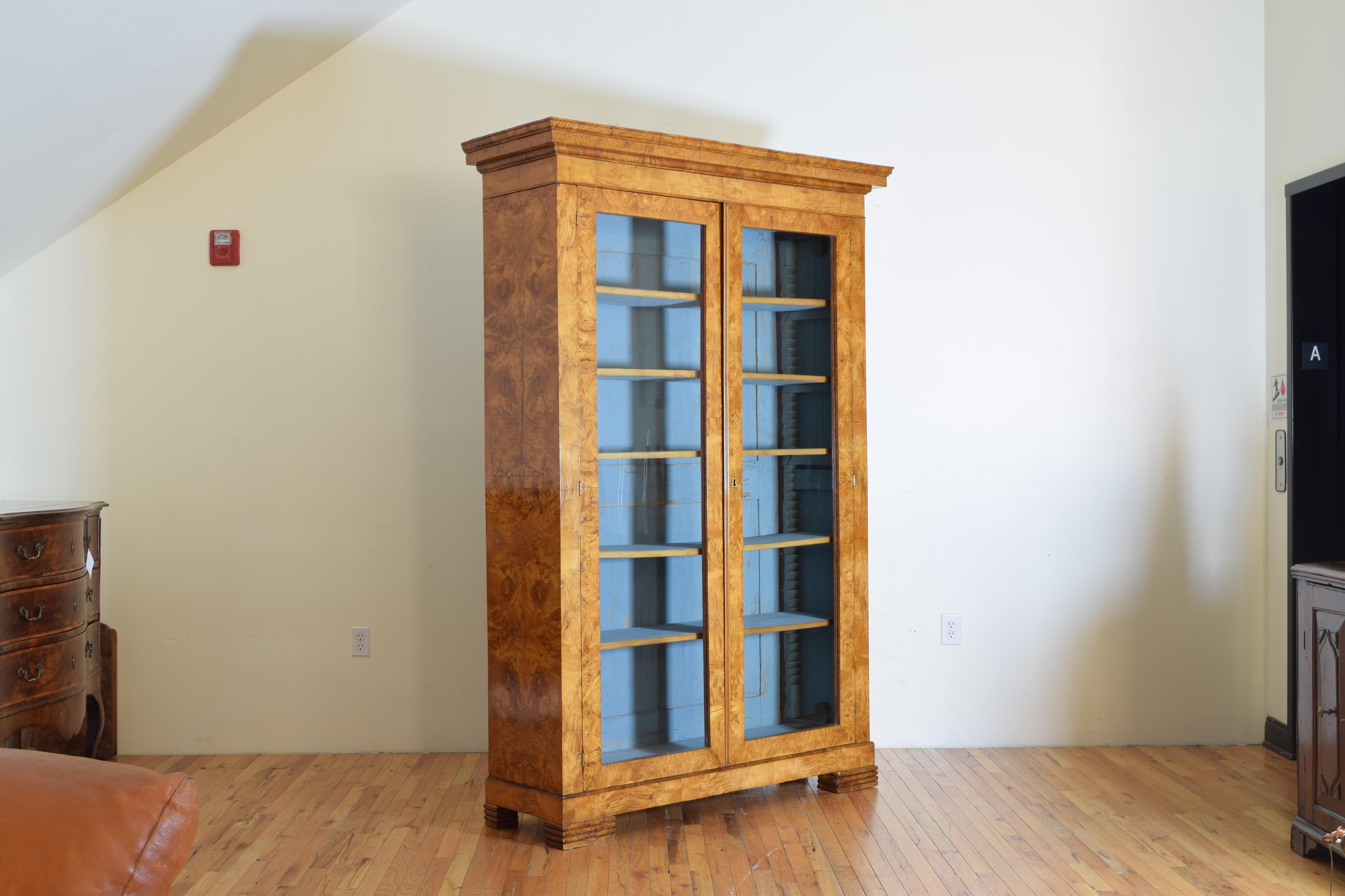 having a molded (removable) cornice above a slightly more narrow case having two glass-pane doors with hand planed and painted adjustable shelves and a secret storage hatch within the cornice atop the cabinet, raised on accordéon feet

Depth at
