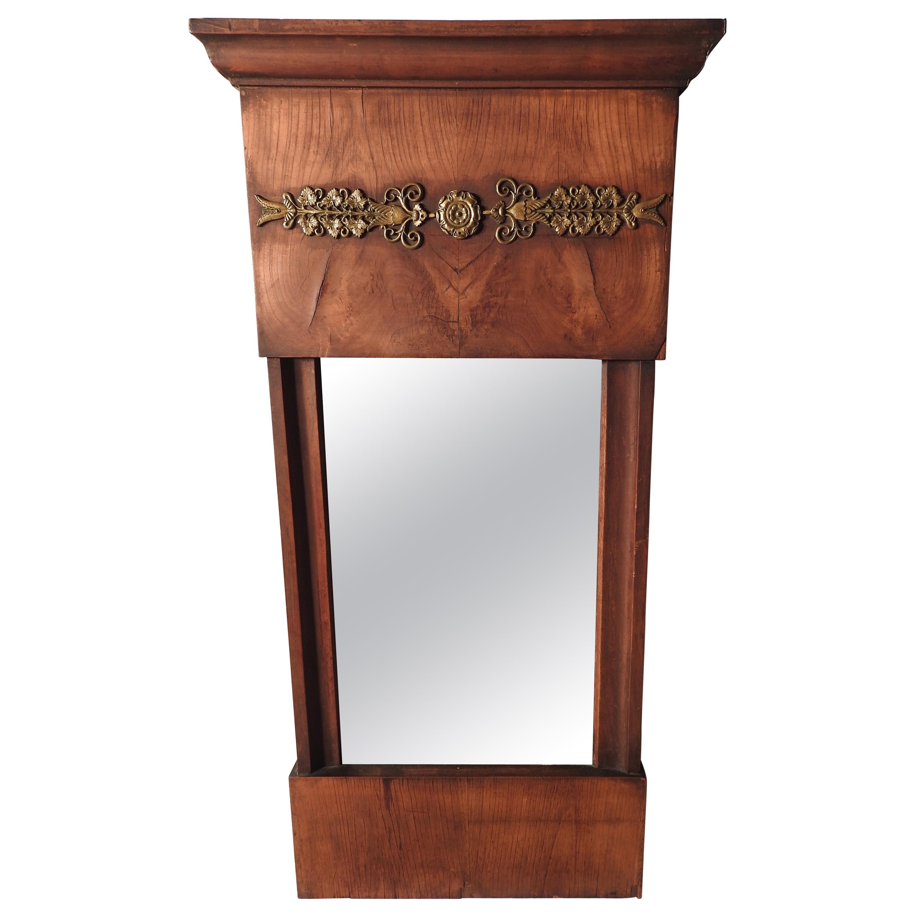 Offering this gorgeous burled wood French wall mirror. The bottom starts just a nice piece of burled wood. Going up from there the sides are the same. At the top is more burled wood and a trim piece and in the center is a long narrow piece of brass