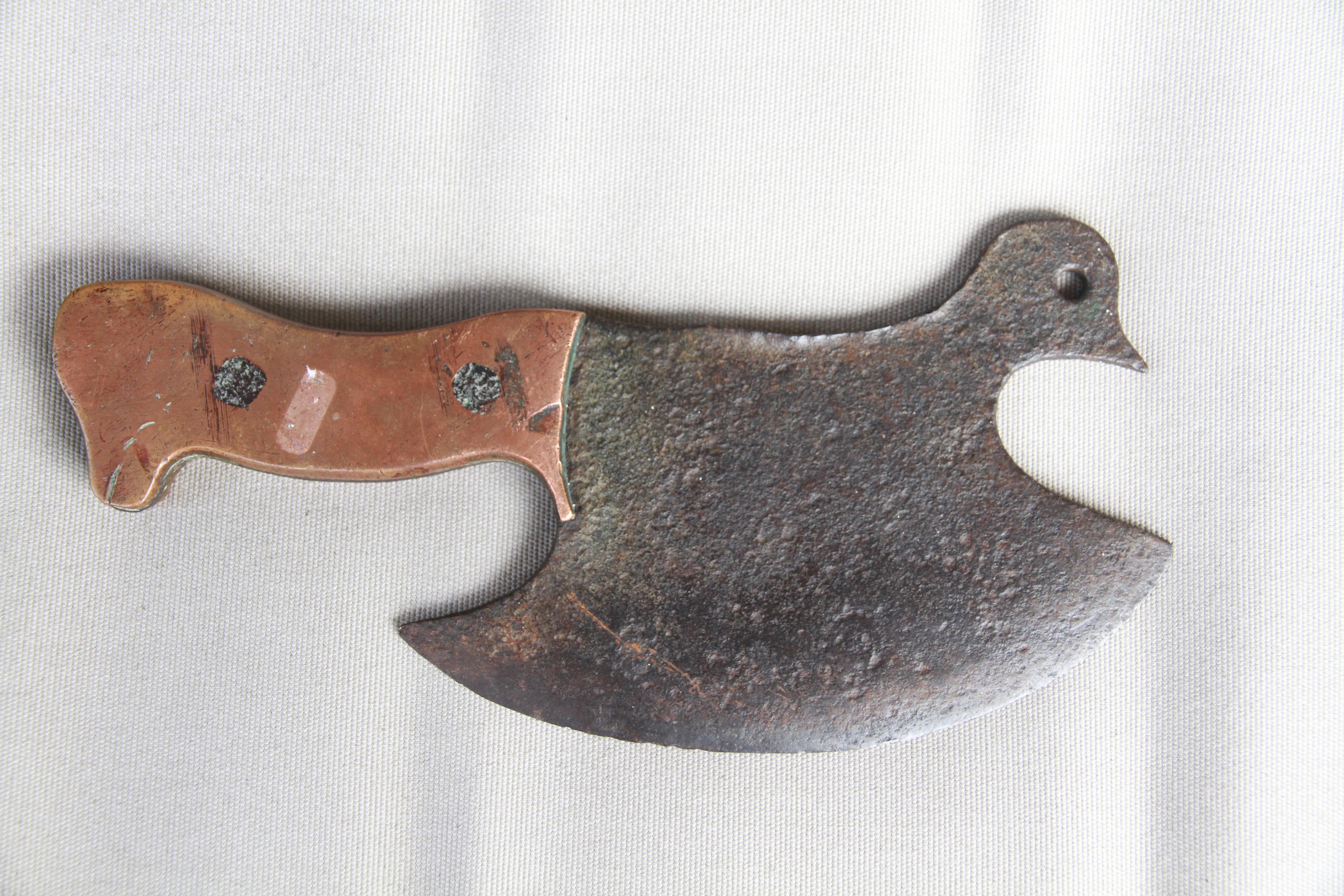 A delightful figurative butcher's cleaver from France in the shape of a bird. With a 7.25 inch blade, the integral handle has copper scales attached with iron rivets.