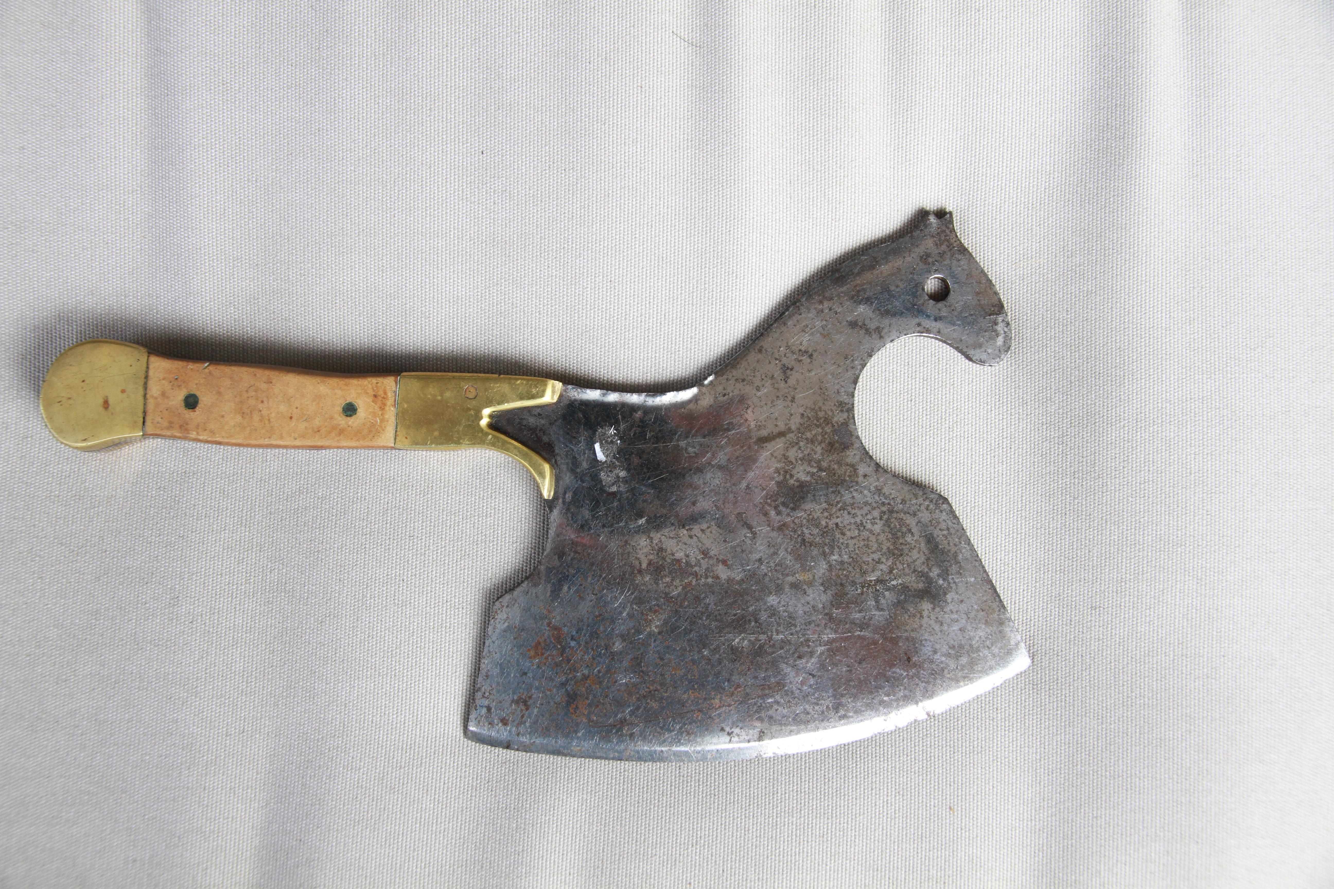 A delightful figurative butcher's cleaver from France in the shape of a horse. With a 7 inch blade, the handle is made of wood and brass.