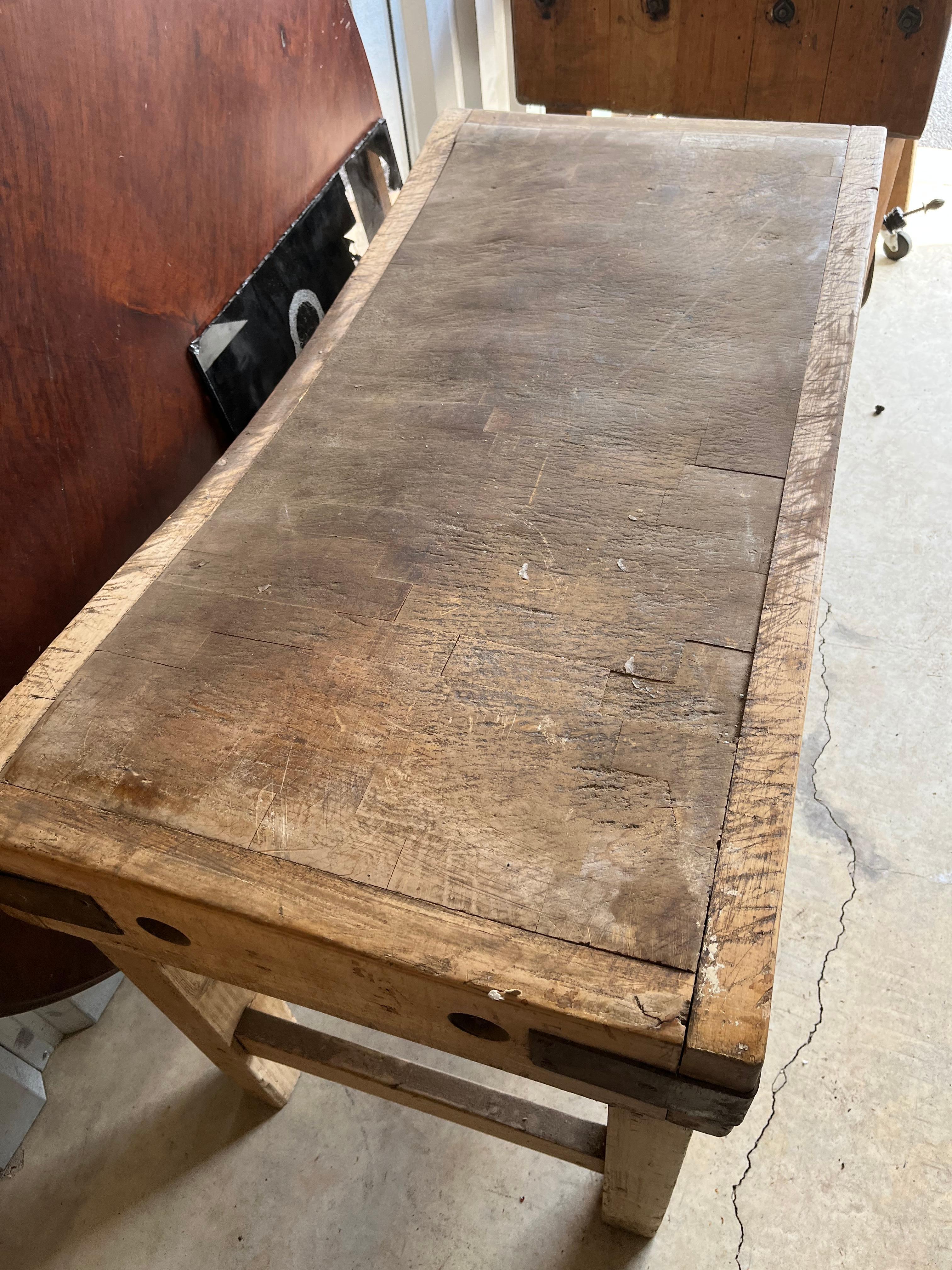 An early 20th century butcher’s block table with reversible top, well worn, with plenty of life still left in it. A great center island in a chef’s kitchen.