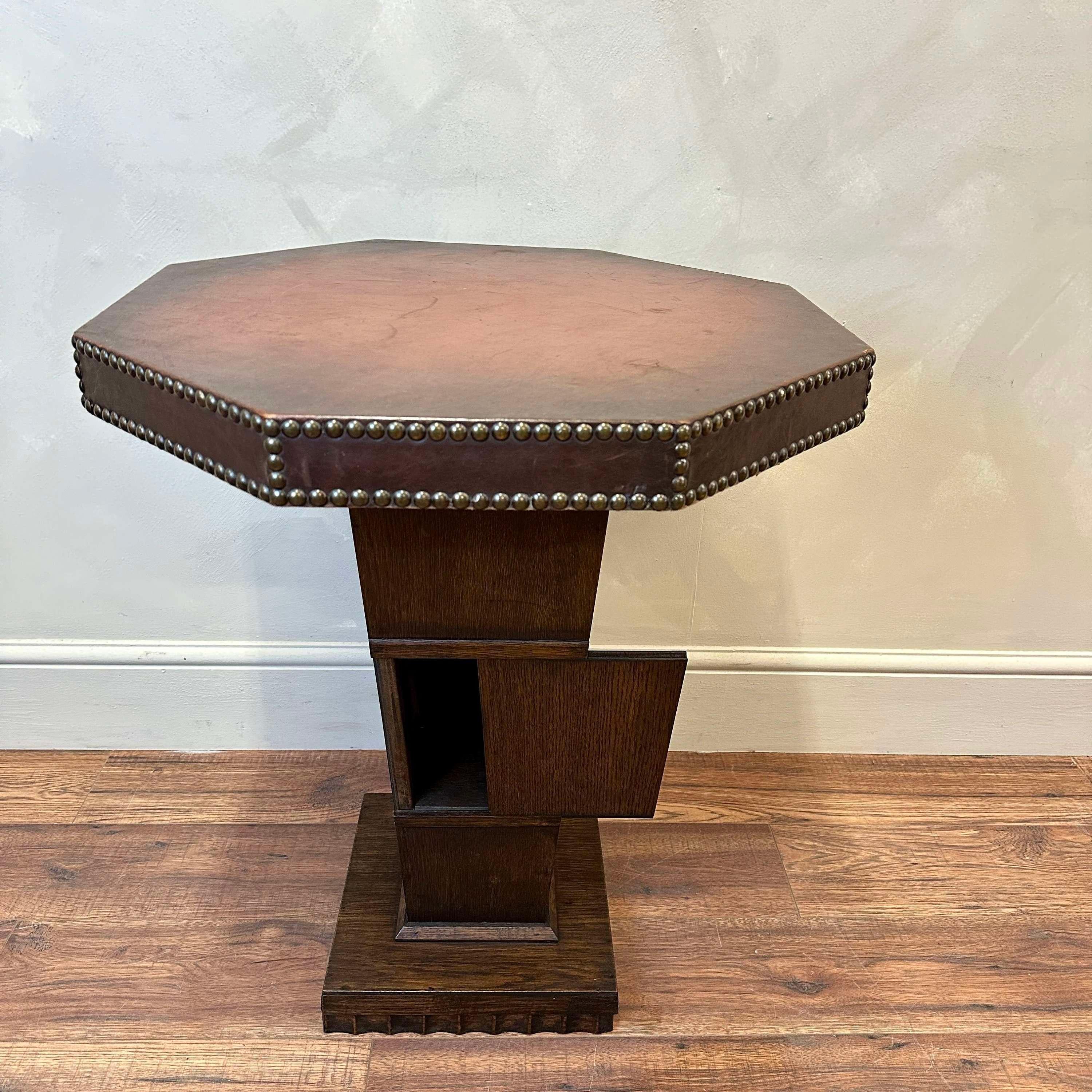 French, studded leather, octagonal top, occasional table. Red-brown colouration. 
Sitting on a single pedestal which unusually, conceals a cupboard.

France, circa 1950.

Height - 65 cm
Top diameter - 58 cm
Please message if any further info or