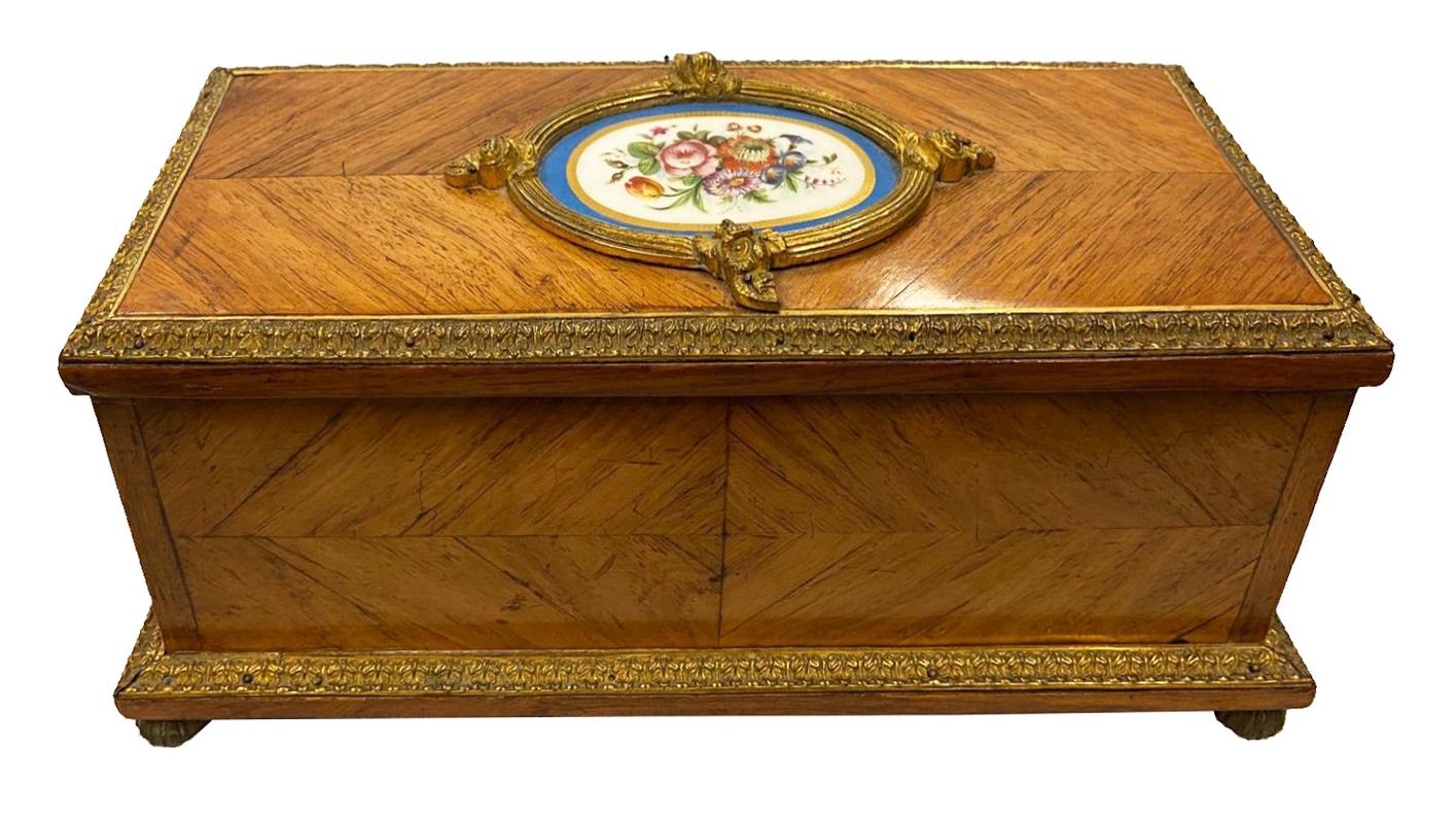 A fine quality late 19th century gilded ormolu and Sevres style porcelain mounted casket, the hinged lid opening to a silk lined interior (needing repair) and raised on ormolu melon feet.
Stamped, Tahan, Paris. Measures: 26cm (10