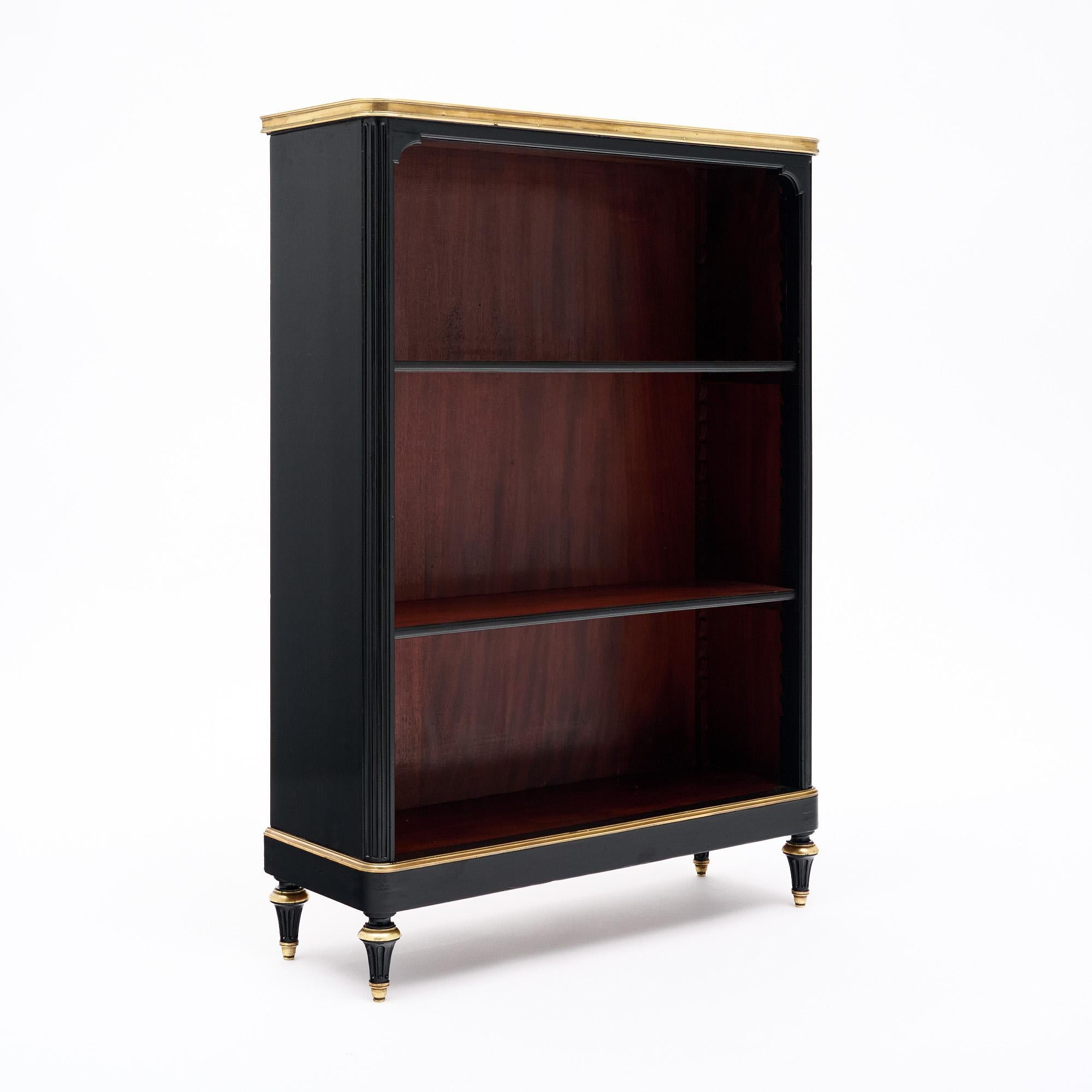 French cabinet ”Bibus” made of mahogany and finished with a Museum quality French polish. Featuring adjustable shelves and gilt brass trims throughout and “Toupies” legs. A stunning intact green marble slab tops the piece inserted in an opened brass