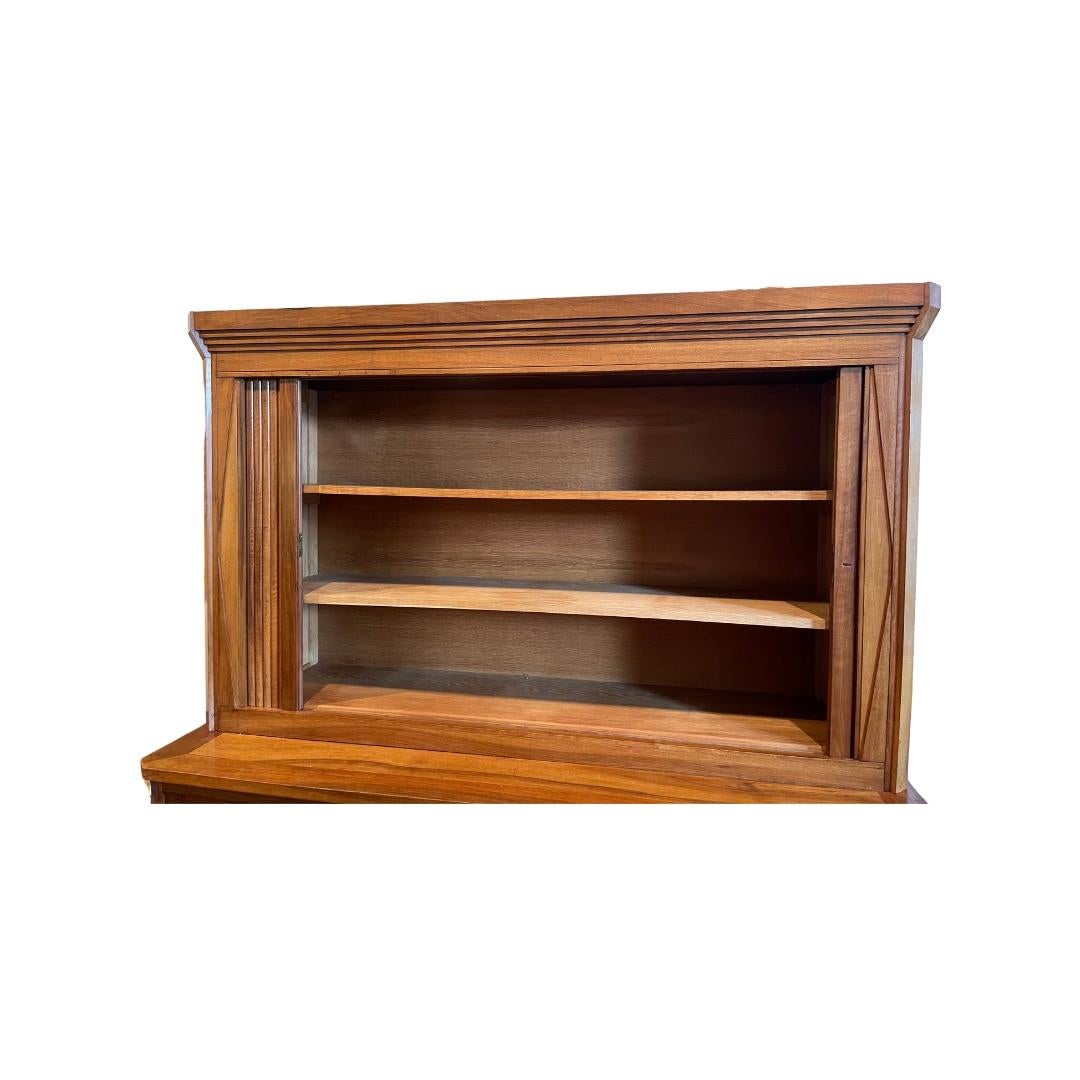 Large, French, 1940s cabinet with elegant self-roll tambour doors and deco-style moulding. This is beautifully crafted of walnut wood with a spacious base cabinet. Perfect for storing and displaying china or other collectibles. The top storage unit