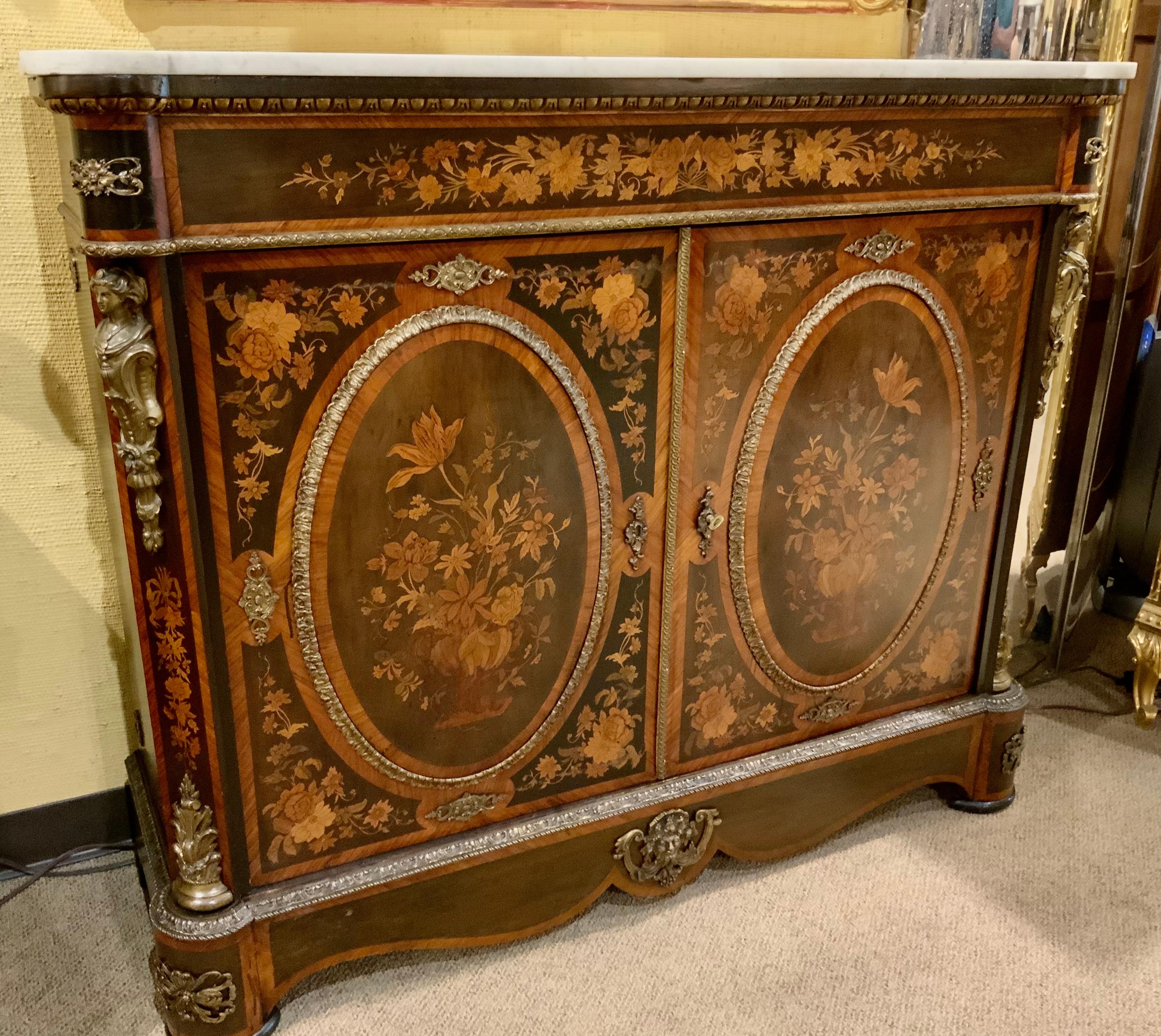 Exceptional and intricate marquetry work using various exotic woods.
Including kingwood, rosewood, satinwood make this piece especially.
Beautiful. Two cabinet doors open to interior with two shelves. The white
Marble top is without cracks or