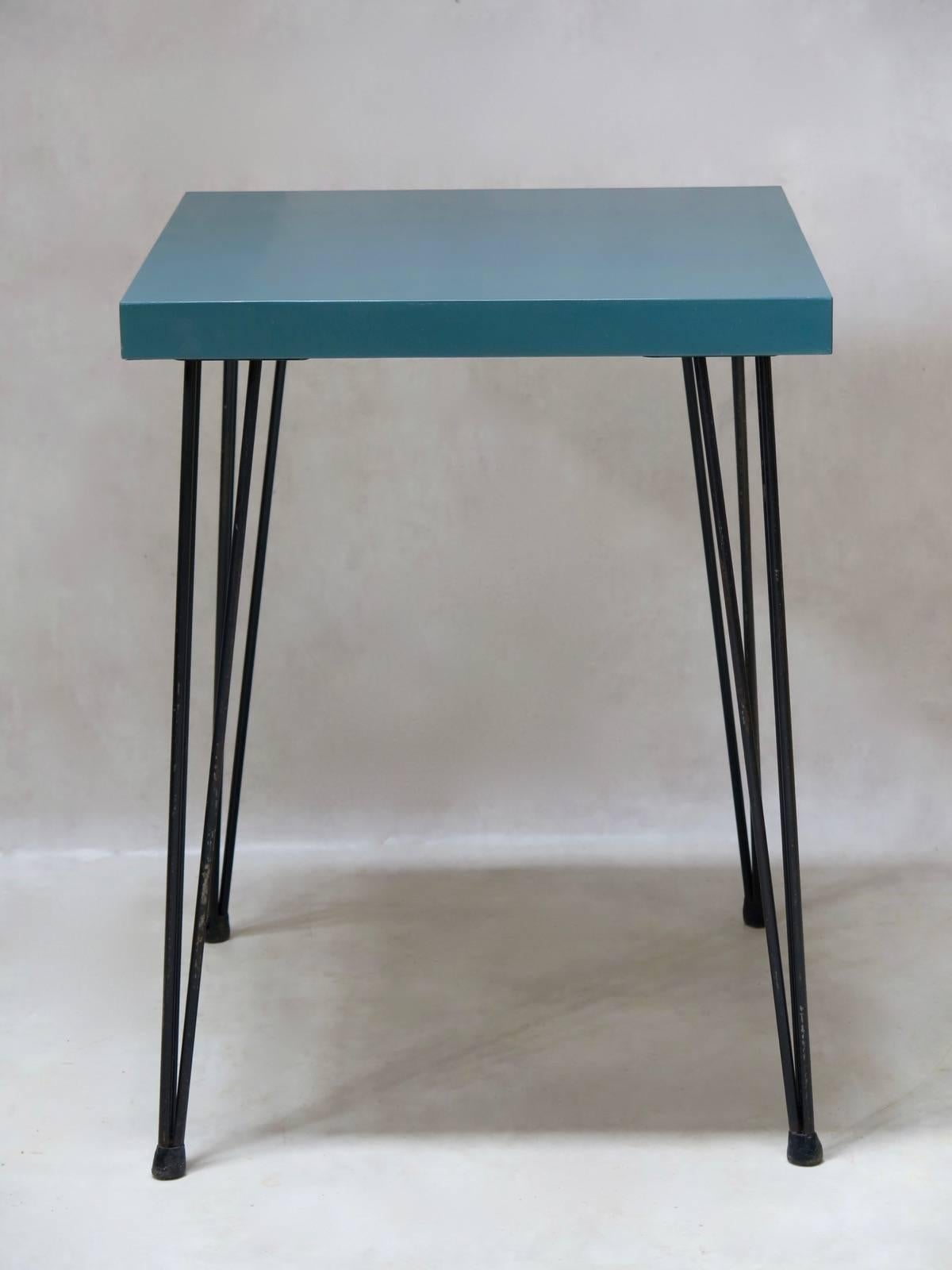 Tavoli quadrati dal design gradevole, piuttosto piccoli, con piani in compensato verniciato, sollevati da gambe in metallo nero affusolate e strombate.

8 disponibili.
