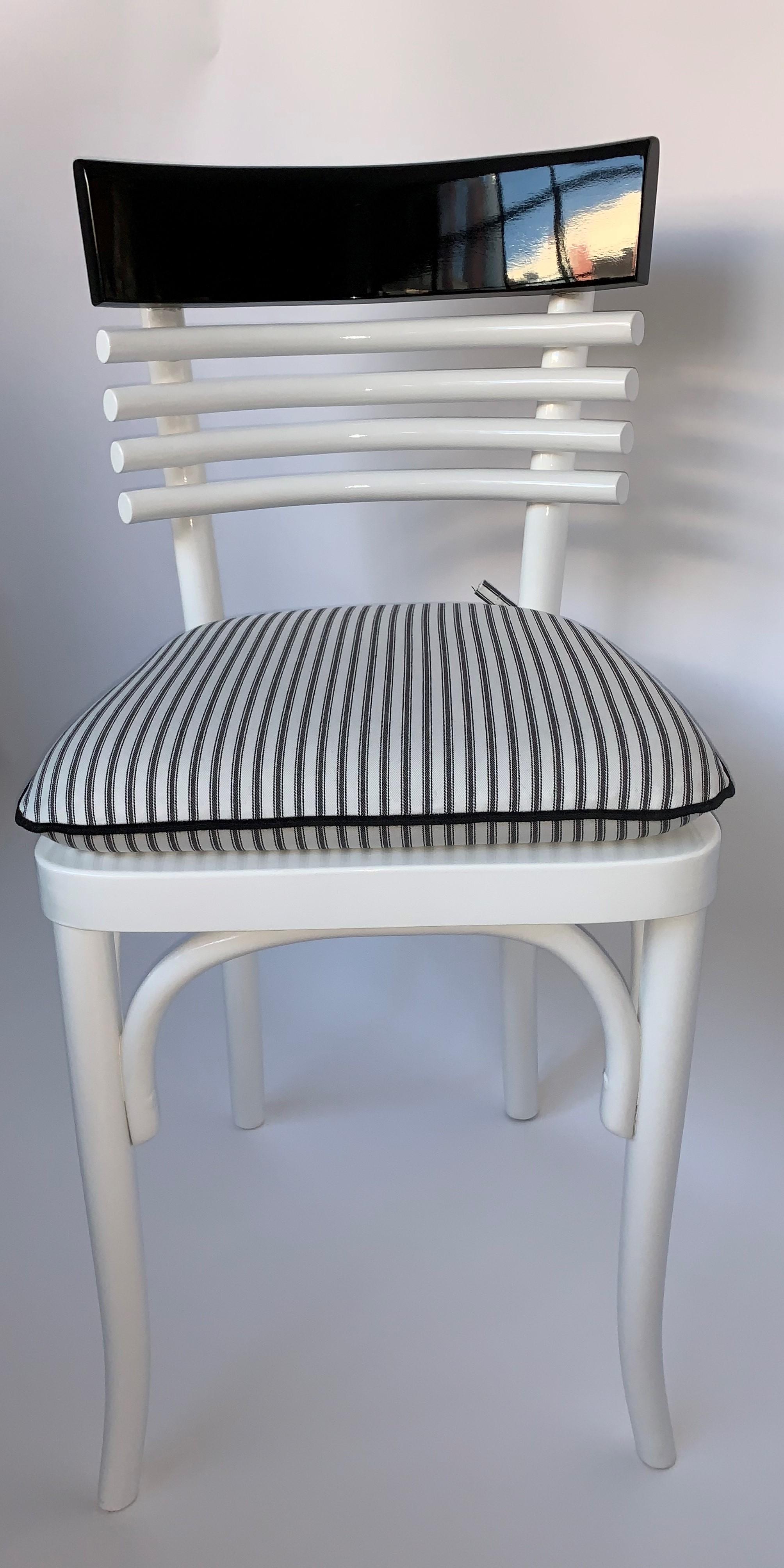 6 Vintage French Cafe chairs. Each chair has been impeccably refinished with a black and white lacquer. The chairs come with a custom cushion made with a coordinating black and white ticking stripe fabric.

Property from esteemed interior designer