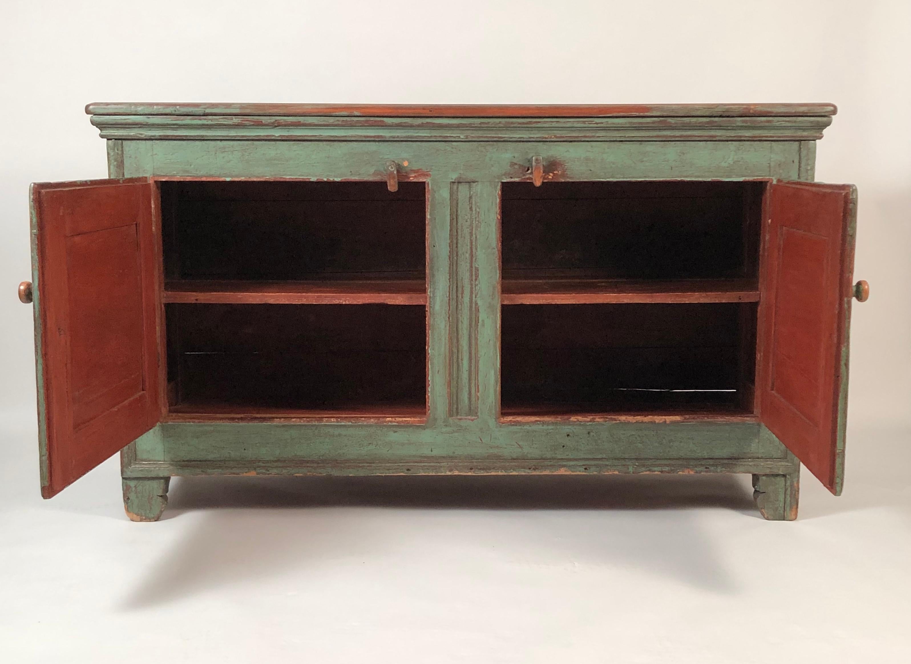 An antique French Canadian country side cabinet in beautiful old green paint, of rectangular form with two cupboard doors, each with an inset panel. Perfect as a buffet or server or anywhere cabinet world be useful. Great color and surface and