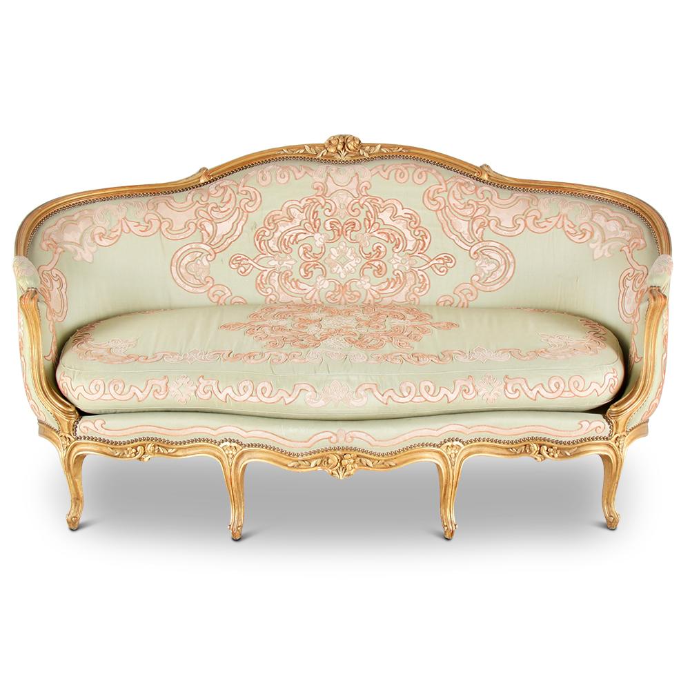 An early 20th century French Louis XV style canapé settee with a finely carved and gilt frame, the original silk upholstery embellished with elaborate damask appliqué and embroidery.
An elegant and comfortable piece.


 