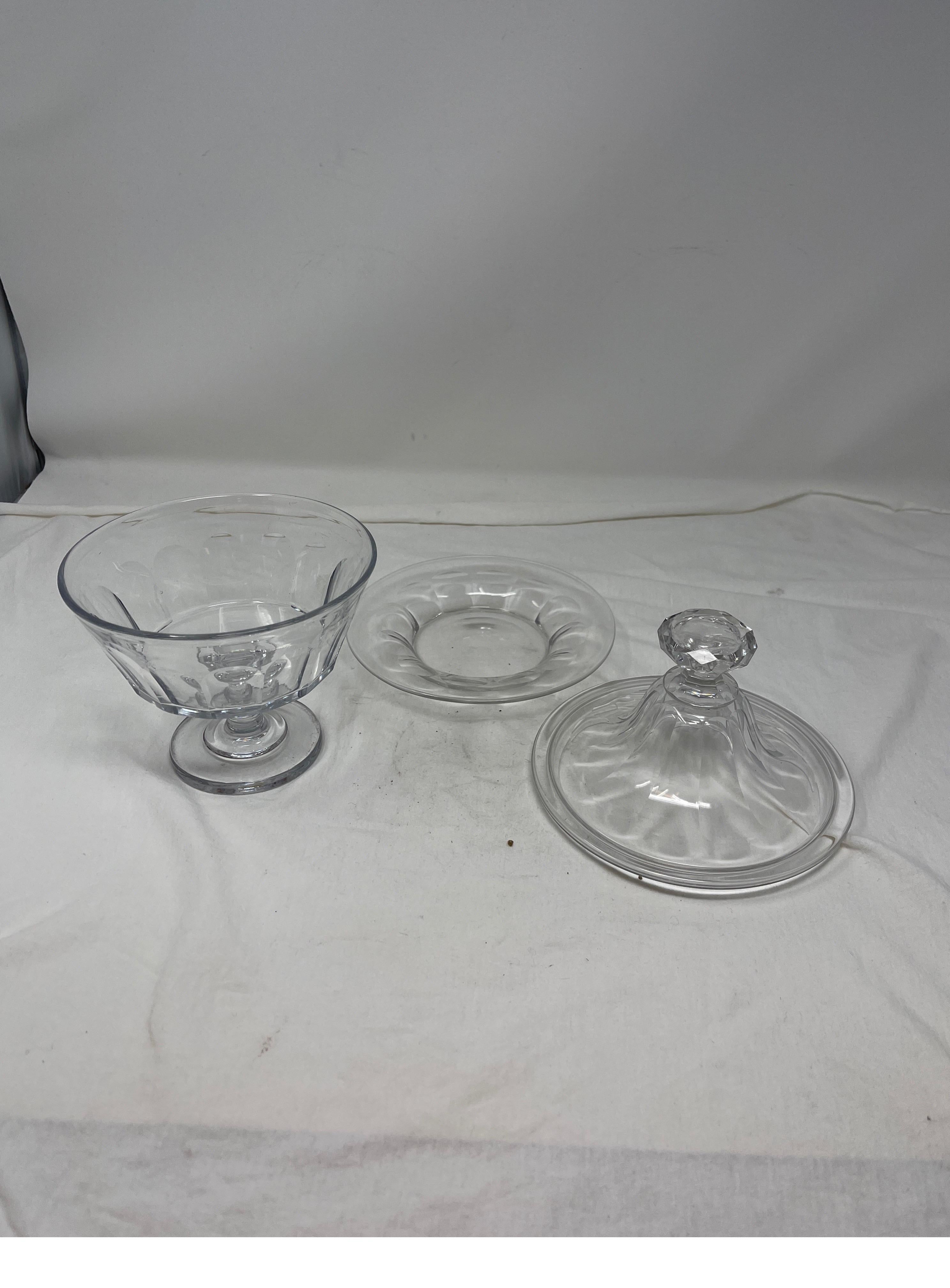 Timeless French glass candy jar that includes a petite plate. This fluted and faceted candy jar works to present your most delicious candy or can serve as a cotton ball holder for your vanity.

3 pieces. Plate, jar, and lid. 
Measures: 8” H x 6