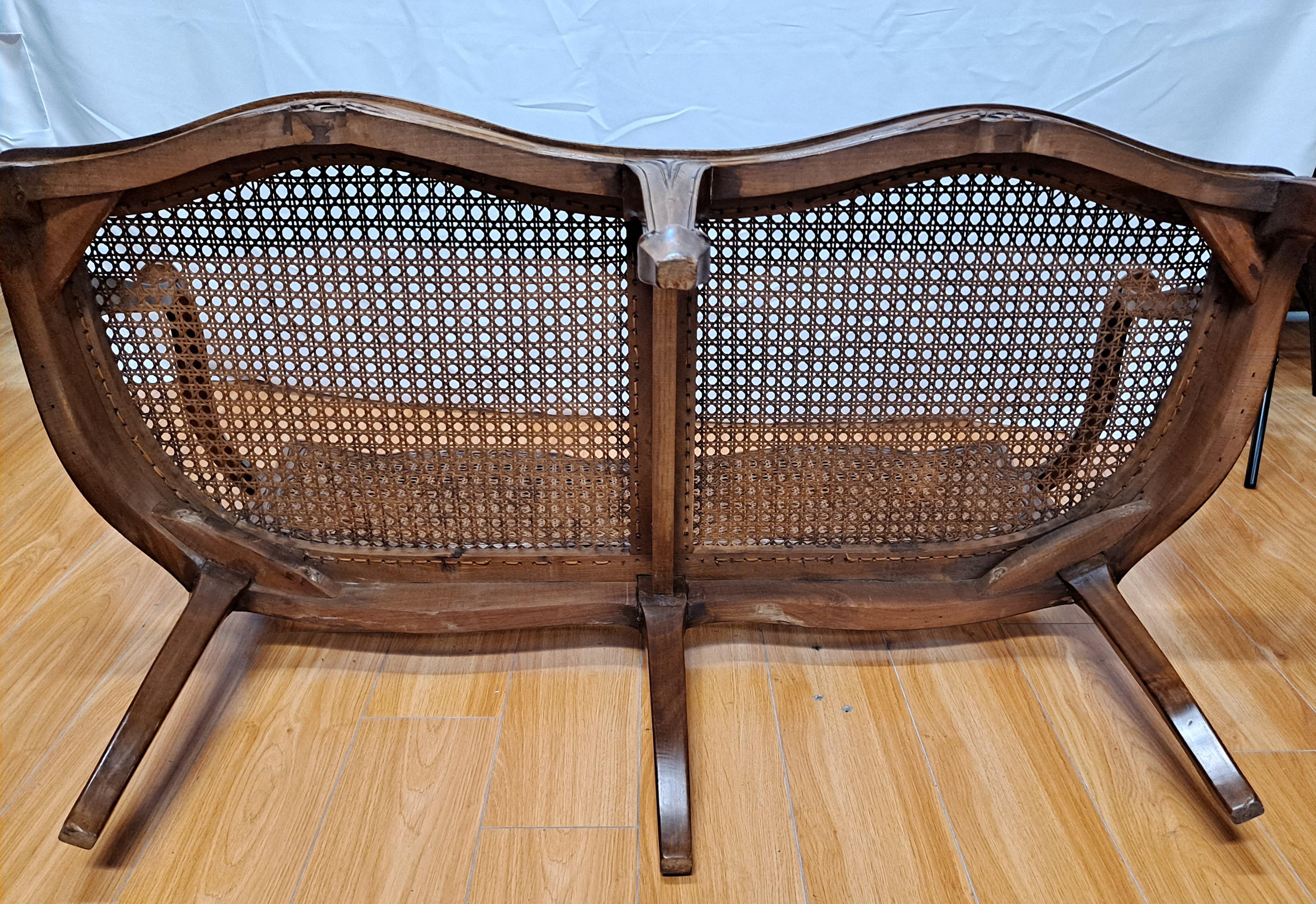 This Classic French bench features beautifully carved walnut with a caned seat and back.
Mid-20th century
Comfortably seats two.

Dimensions: 47
