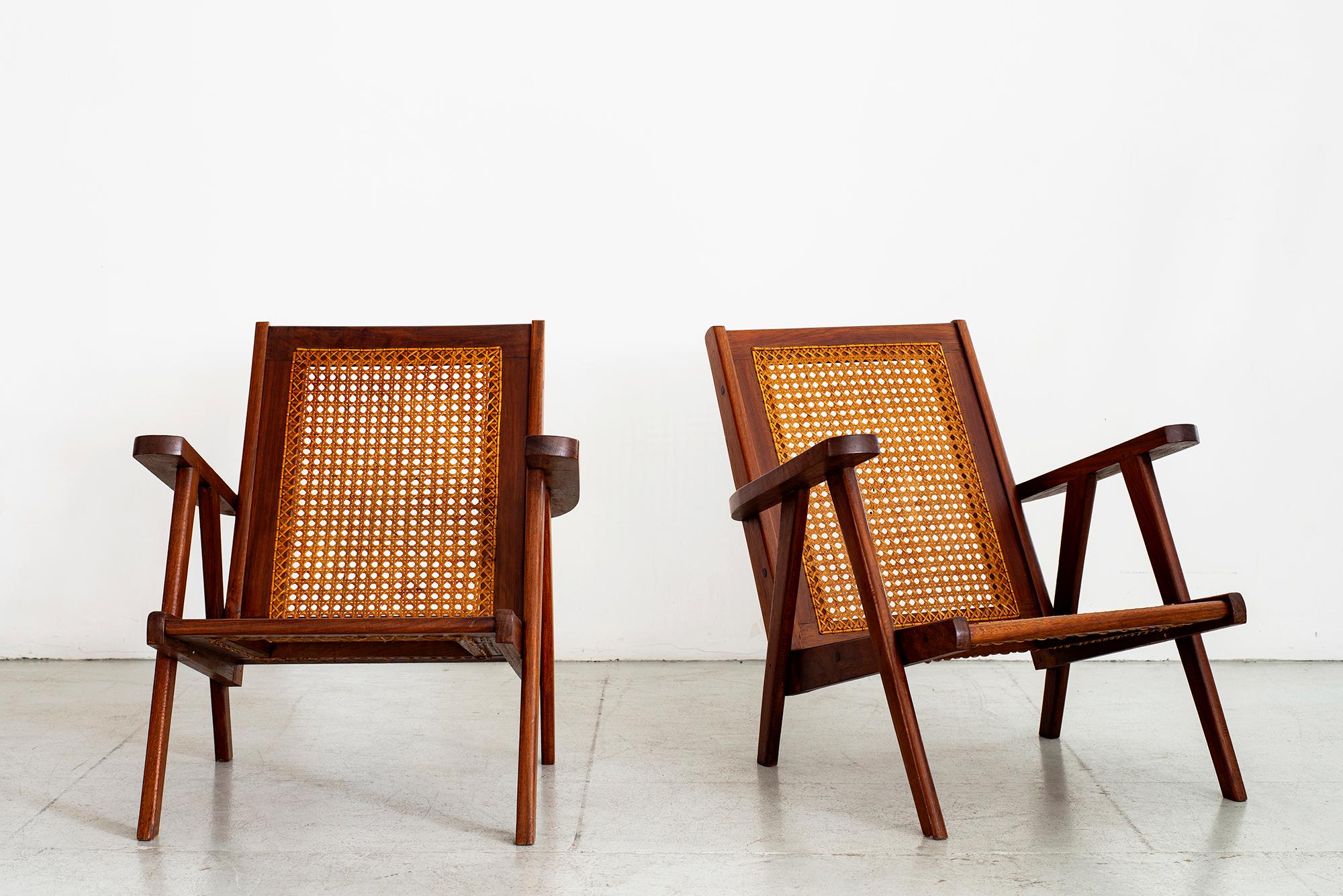 Great pair of French paddle armchairs in teak with caned seat and back.
Great angular shape similar to Pierre Jeanneret
Original caning and wonderful original patina to wood.