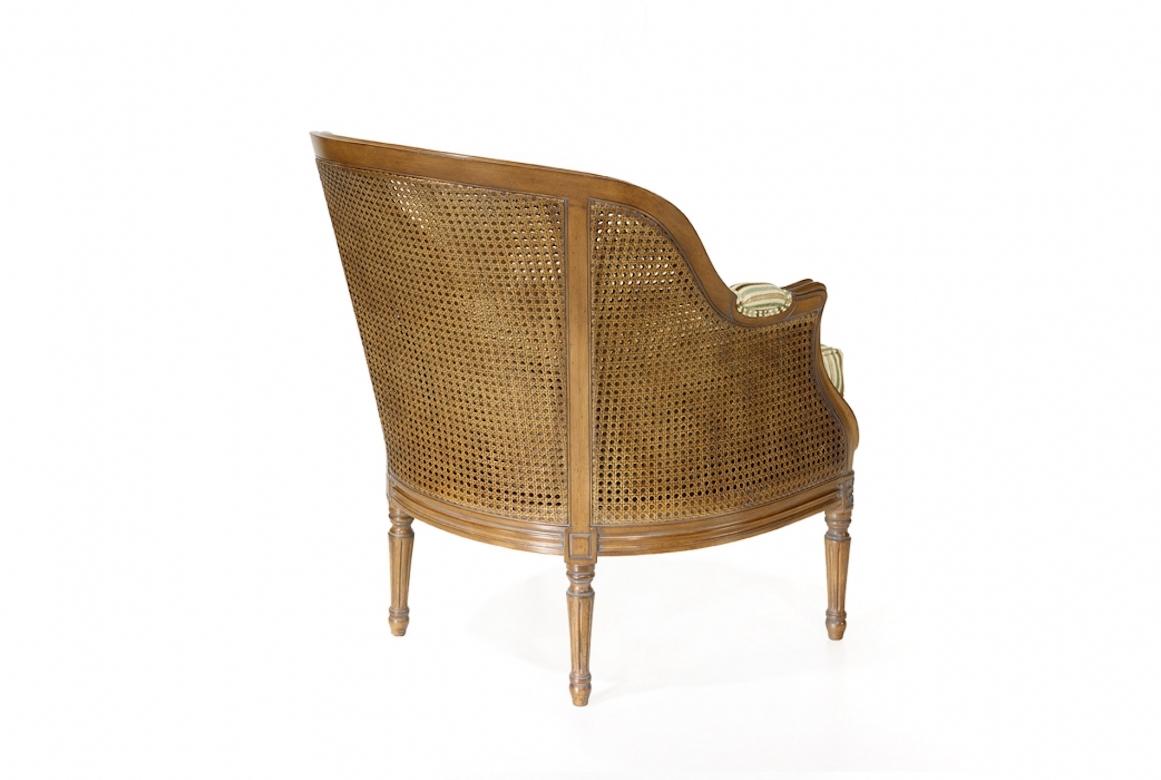 A stunning French caned Vallencourt armchair, 20th century.

The caned Vallencourt armchair is shown in cherrywood with an Avignon finish. A Classic caned Louis XVI-style armchair, the Vallencourt has a coved en cabriolet back and fluted en