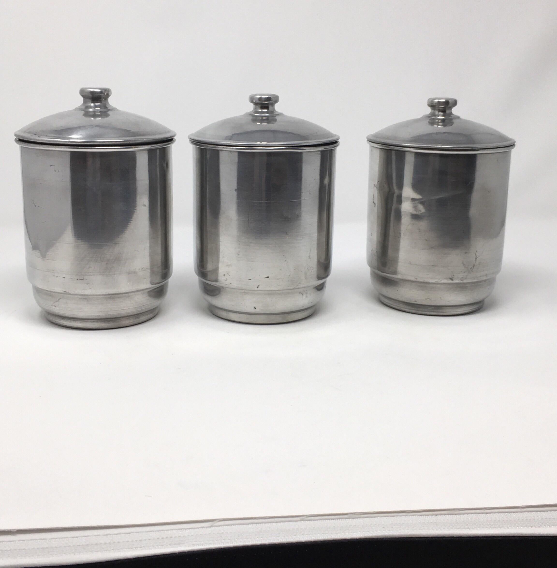 This French tin canister set consists of three equal size lidded canisters. The canisters are tin with brown plaques and silver lettering, Cafe- coffee, Sucre - sugar and Chicoree - chicory. This lovely set will surely add French charm to your
