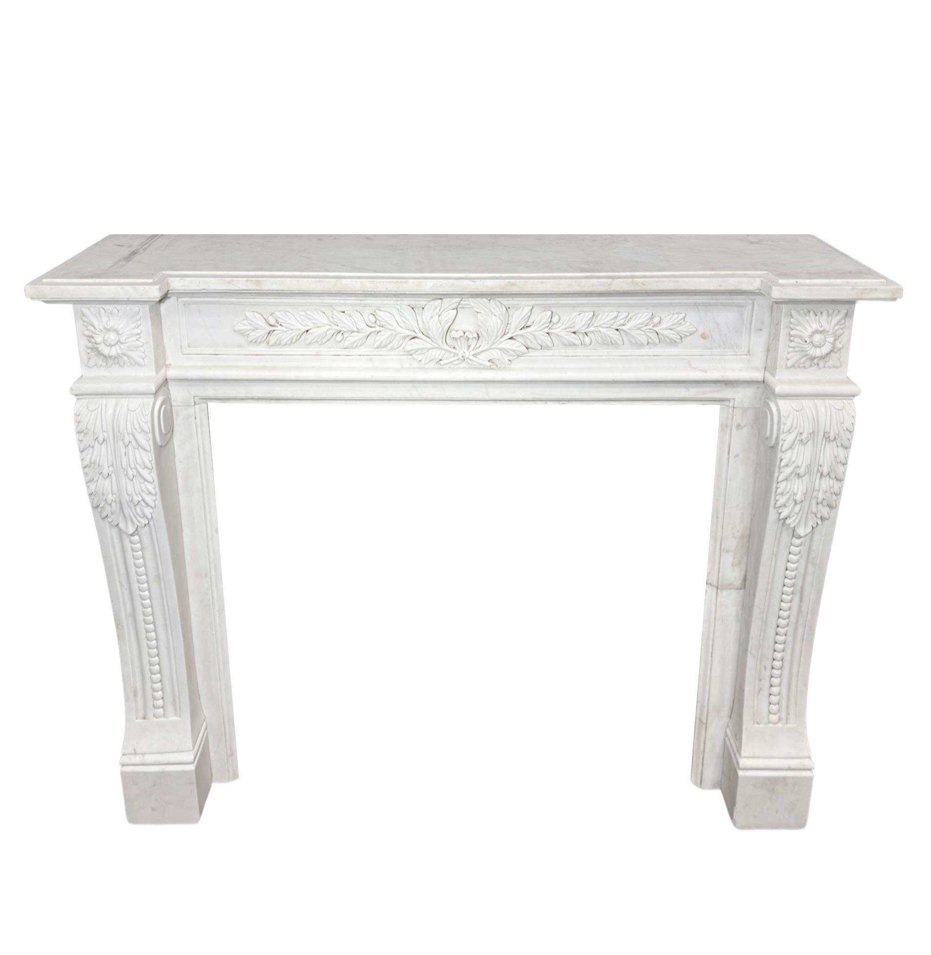 Crafted with the finest white Carrara marble from France, this Louis XVI style mantel from the 1890s boasts intricate carvings. Elevate your space with a touch of elegance and timeless beauty. Made from high-quality materials, this mantel is sure to