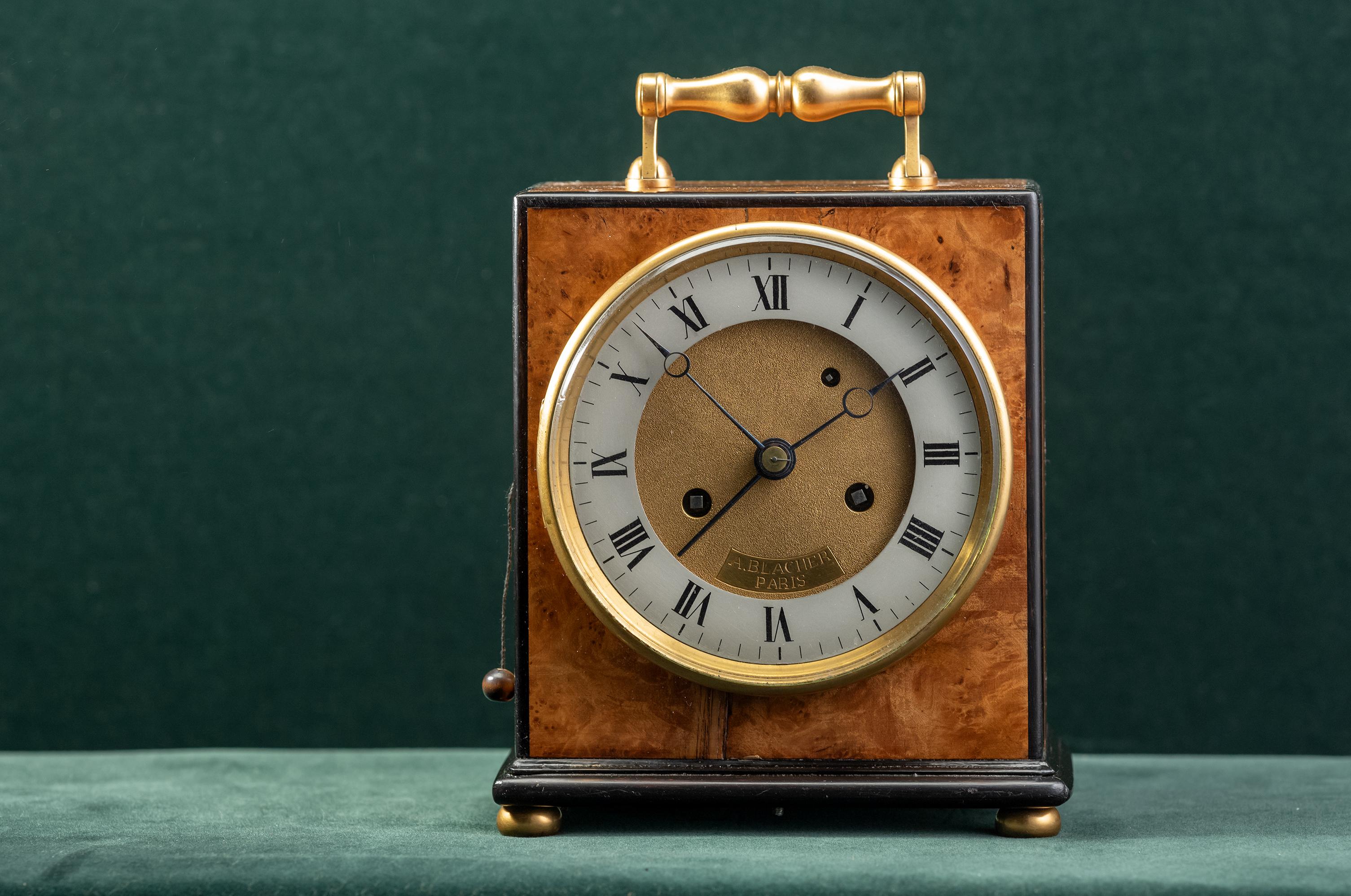 French clock signed A Blacher paris, dated: ca 1850
The walnut veneered case has ebony pipings and a gilded handle, bezel and ball feet.
The movement is also signed A Blacher.
The Breguet type hands indicate the time on the silver-plated chapter