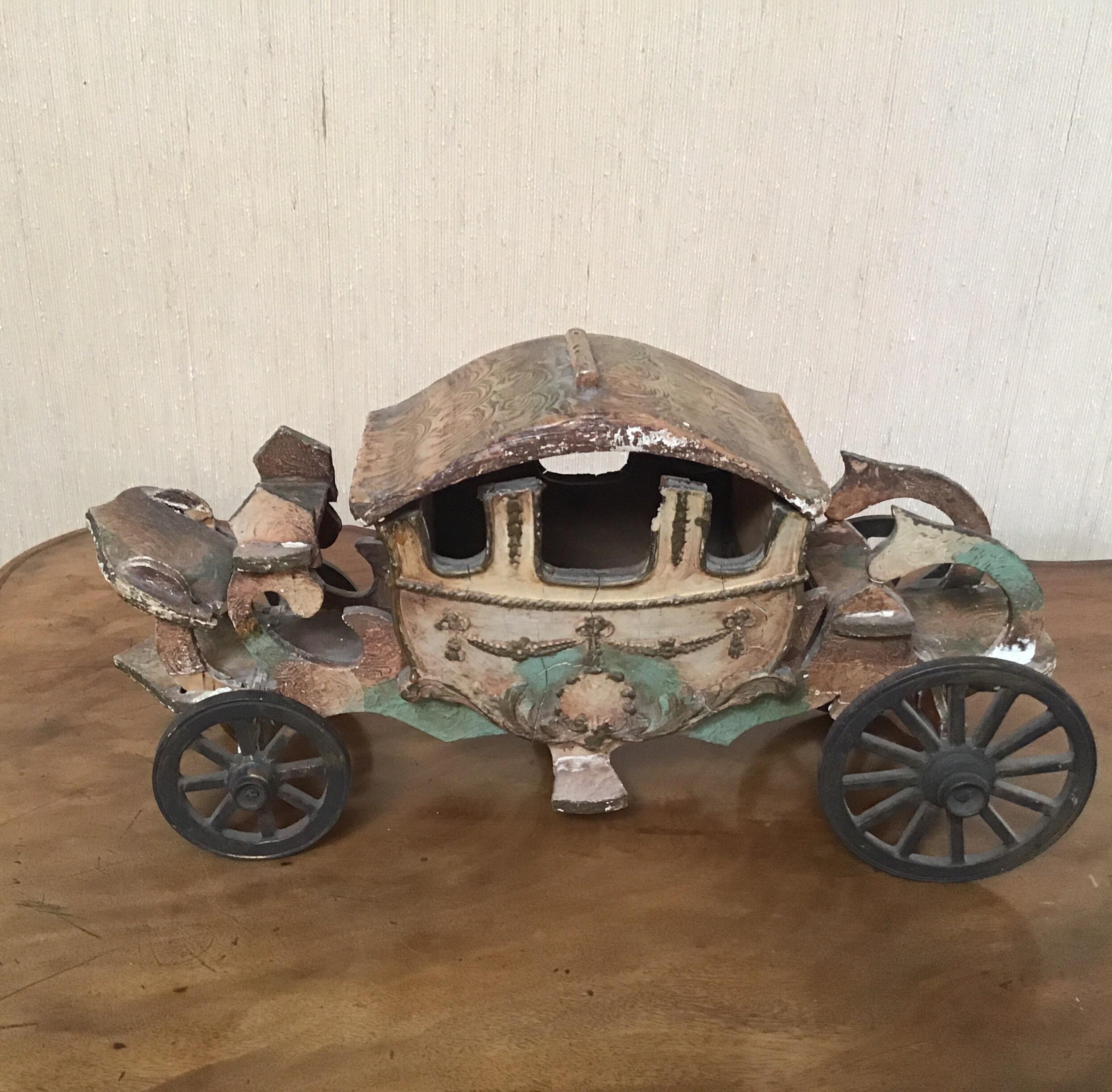 French architectural carriage model made from wood with metal wheels.
