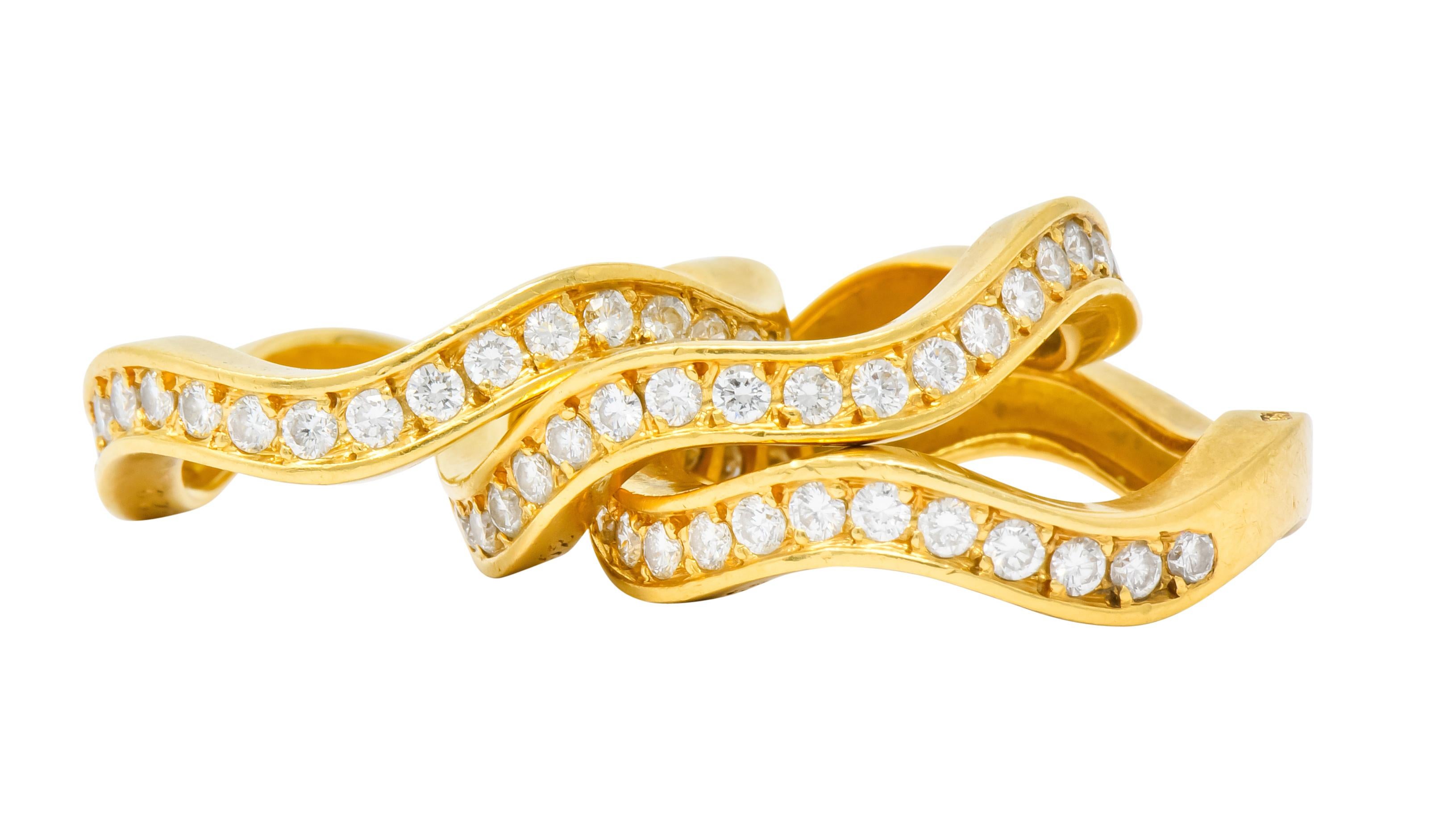 Designed as three waved bands that nest together as a stack, with a matte gold finish

Each set to front with bead set round brilliant cut diamonds weighing approximately 1.56 carats total, F/G color and VS clarity

Each fully signed Cartier and