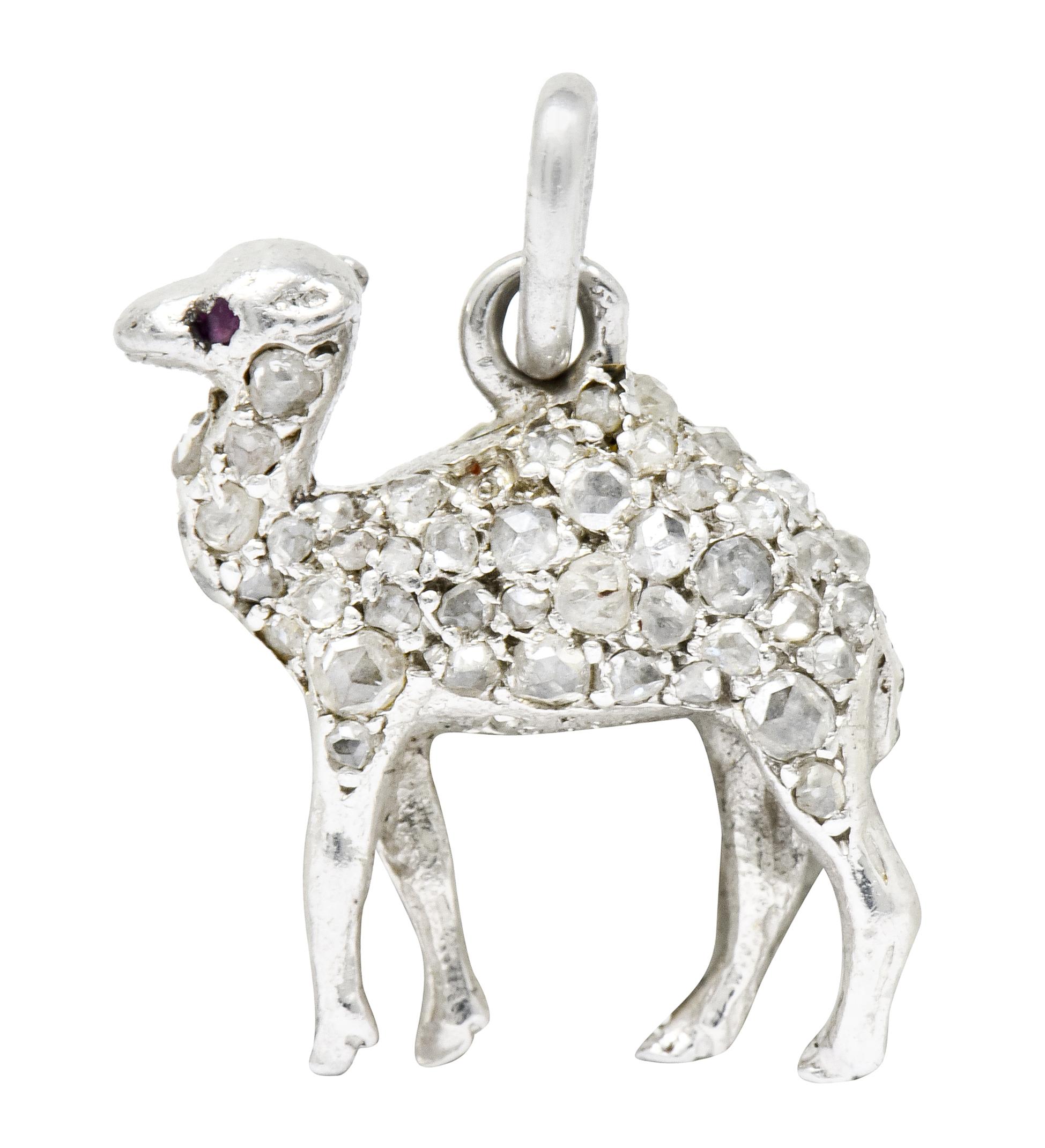 Designed as a jauntily walking camel with its head held high and ruby accent eyes

Pavé set throughout with rose cut diamonds of varied size and color

Completed by jump ring bale

Tested as platinum

Fully signed Cartier with French assay