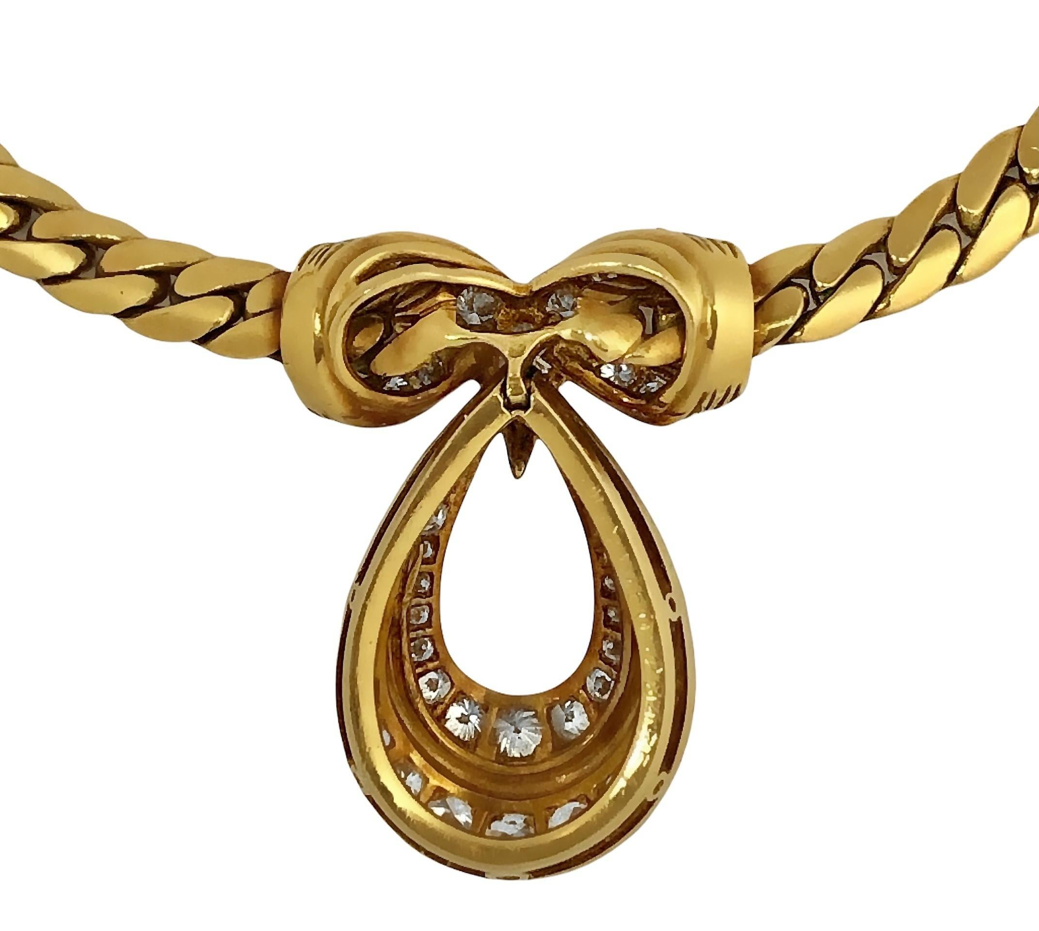 This lovely gold and diamond necklace from the esteemed maker Cartier is crafted to the very highest of French jewelry making standards.  At it's center is a fixed station deftly set with fifty brilliant cut diamonds having a total approximate