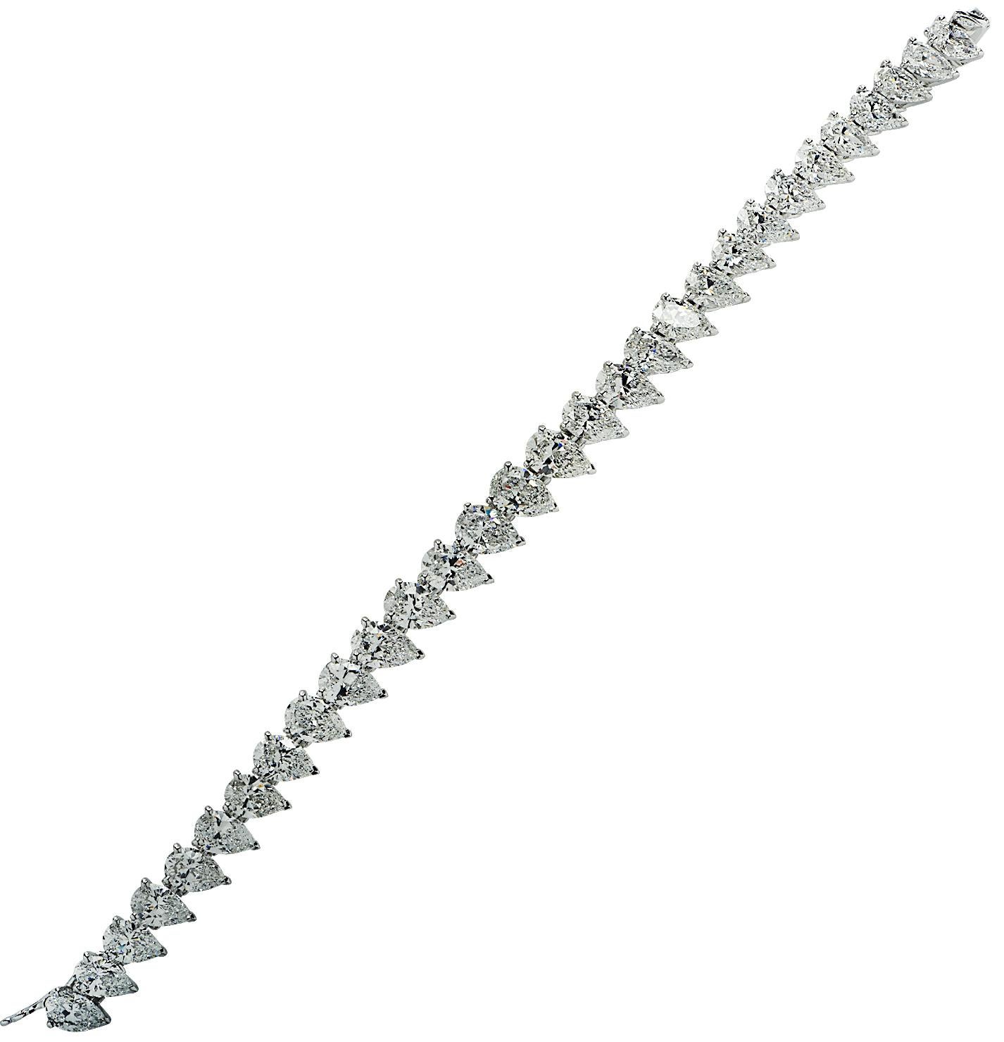 From the House of Cartier, this sensational straight line diamond bracelet, crafted in platinum, features 30 Pear shaped diamonds weighing approximately 23.70 carats total, D-F color, VVS-VS clarity. The diamonds are seamlessly set in 3 prong claws