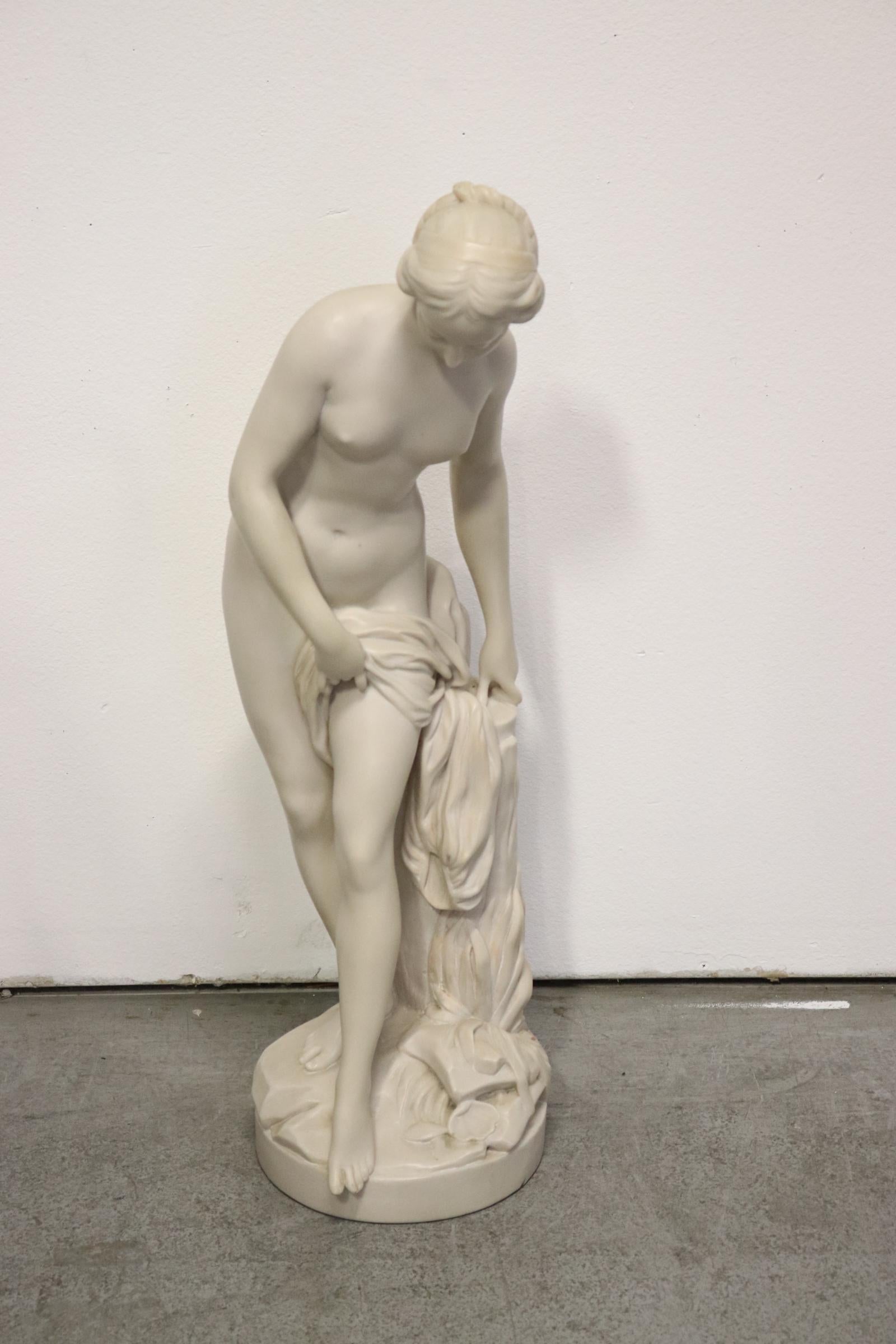 French Louis XV style carved Alabaster figure of Diana after bath. 
Early 20th century.

Nude Diana is standing near a tree stump holding garments, all raised on a conforming circular plinth. 
Inscribed: 