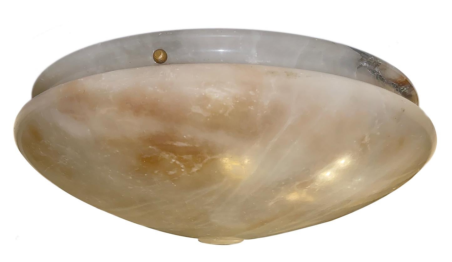 A circa 1920s French champagne-hued carved alabaster light fixture with interior lights.

Measurements:
Diameter 15.25