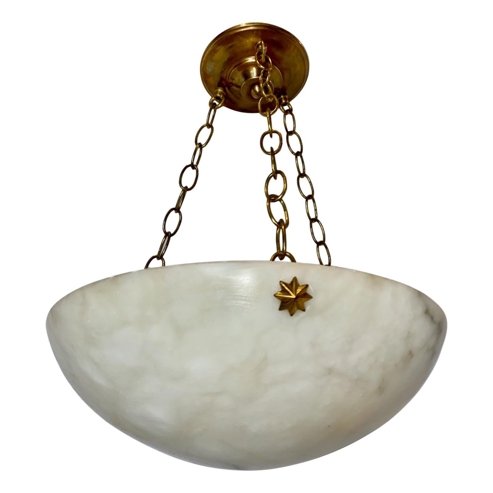 A circa 1920s French carved alabaster fixture with three interior lights.

Measurements:
Diameter 14