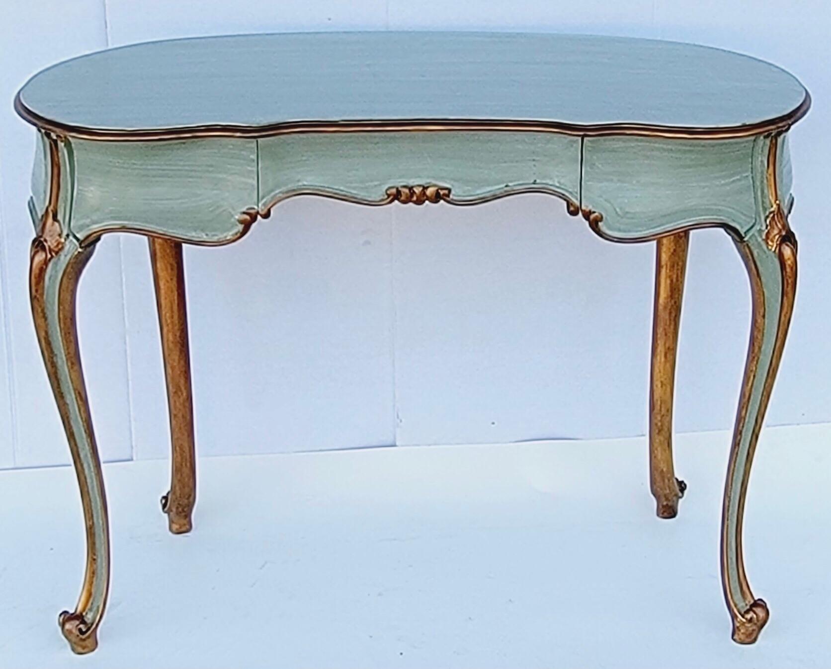 This is a lovely French carved and painted giltwood desk that could also work as a vanity or side table. It is a lovely seafoam color, and the piece does have dovetail construction.
