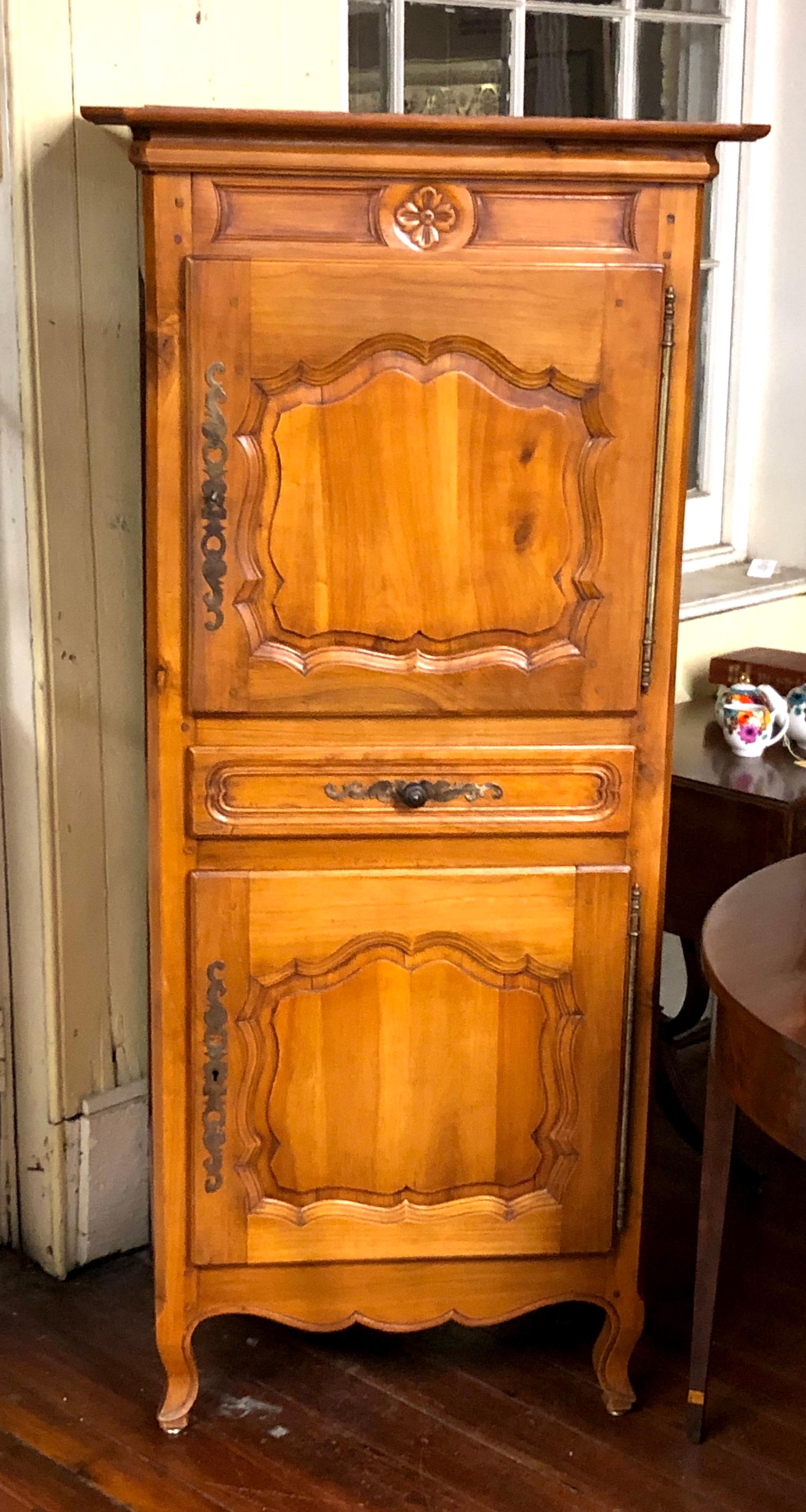 Wonderfully sized Antique French carved cherry Louis XV style Bonnetiere. These useful pieces became fashionable at the late 18th century when women of prominence began wearing large and impressive hats or bonnets. They were used for storing these