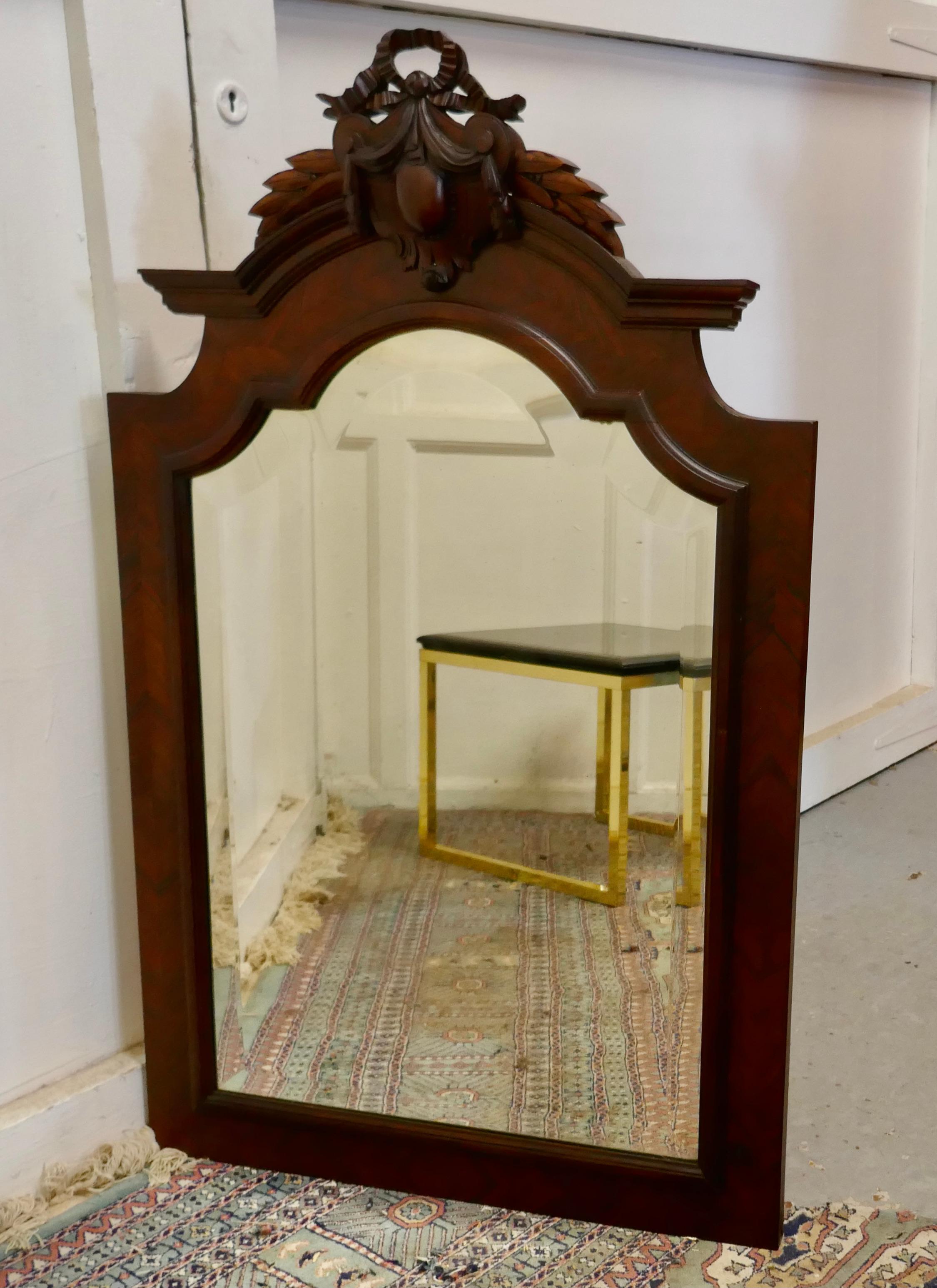 French carved flame mahogany wall mirror

This is a large wall mirror the frame has a large carved crest at the top with a shield and ribbon swags
The Original Bevelled Glass is in good condition, this is an imposing and attractive piece
The