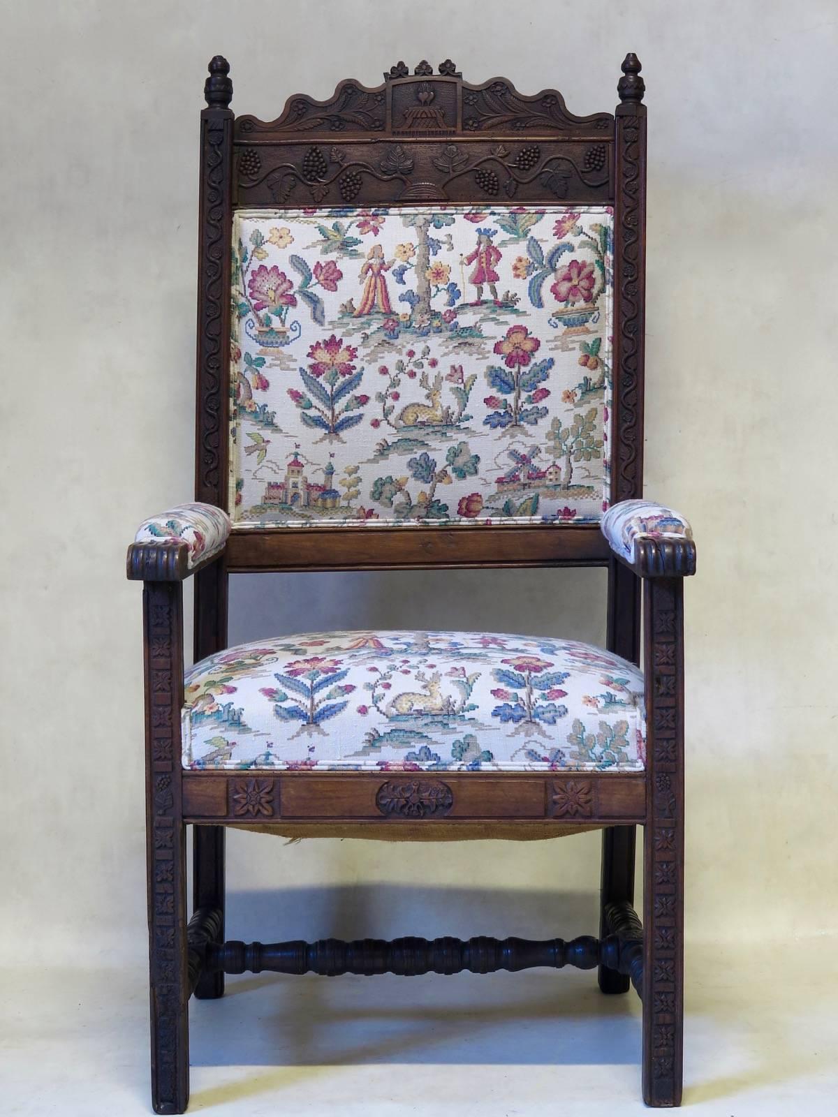 Very lovely Folk Art armchair of generous proportions. The wood (probably oak) is finely carved with an intricate decor. The crest is topped with a sacred heart symbol, and fruit and leaves of the vine. These also serpent down the front uprights.