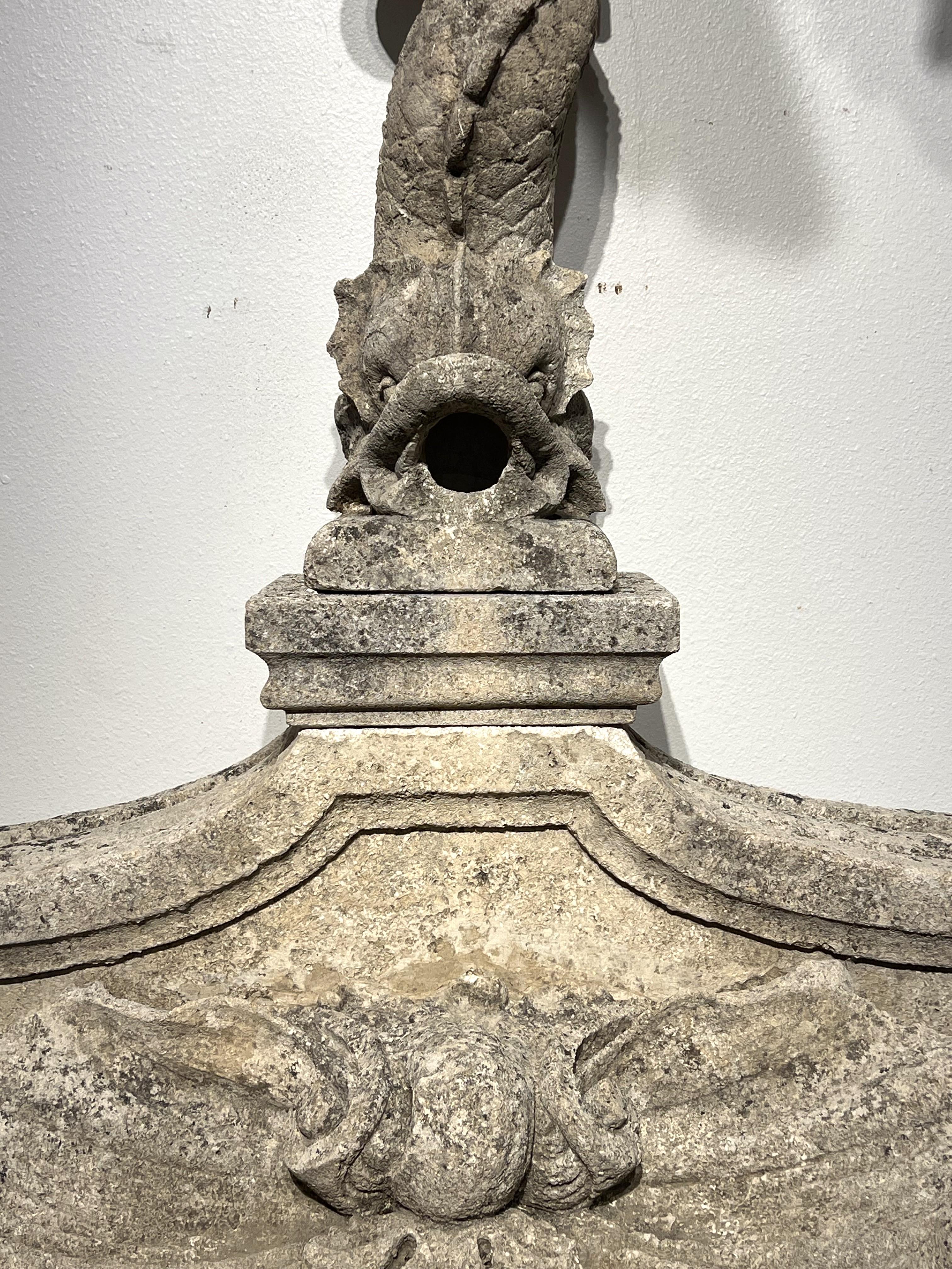 Consisting of four pieces of hand-carved French limestone, this fantastic dolphin fountain element dates to circa 1890 and measures nearly 6.5 feet tall. All four stones are cream-colored and have developed a wonderful patination, but each piece has