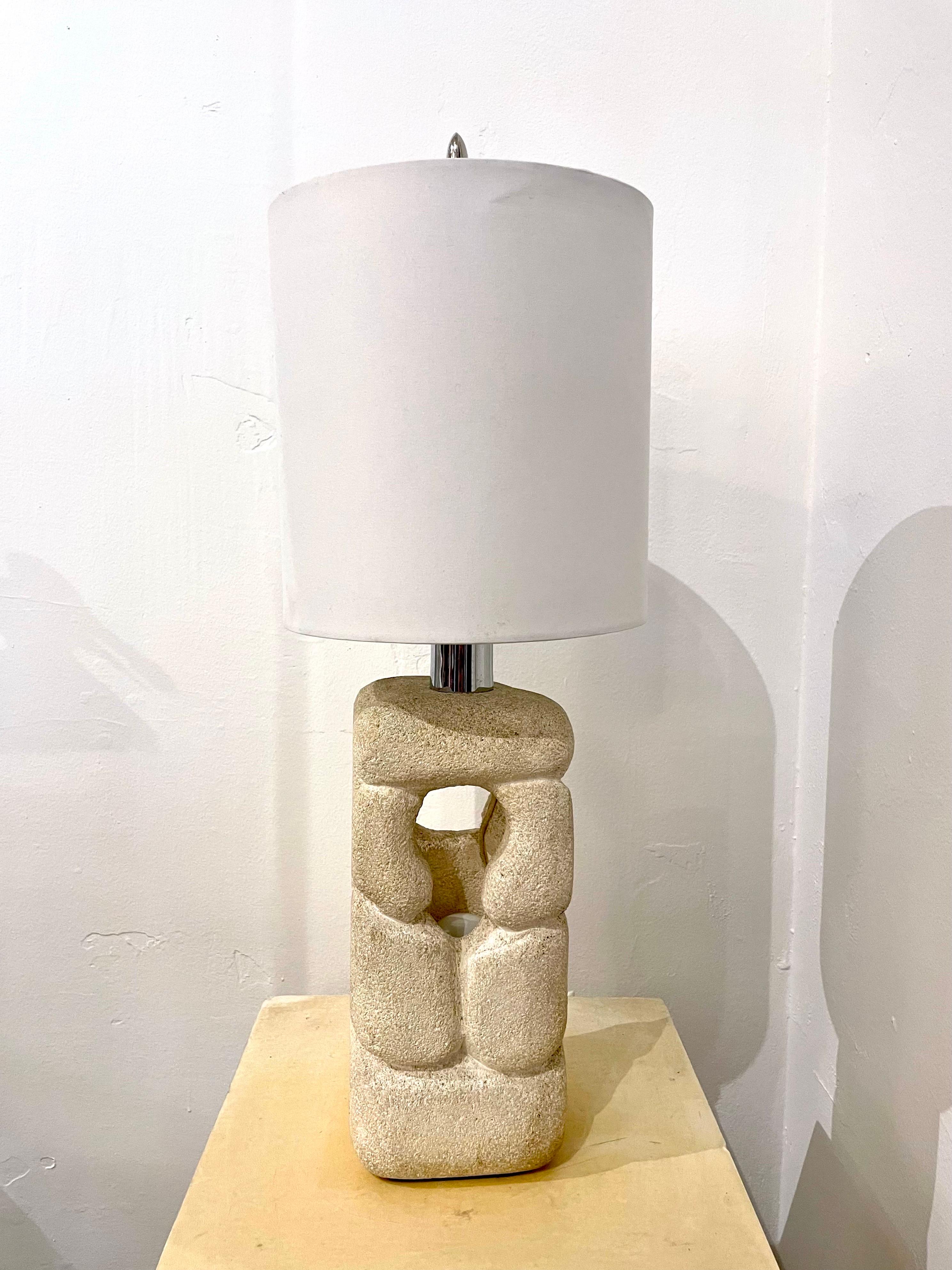 This highly sculptural carved limestone lamp with two light sources (one embedded and one up-light with harp), is organic and abstract in its design. Newly wired with silk cable and switch.

Note: Stone portion alone is 10.5 inches tall, 5 x 5