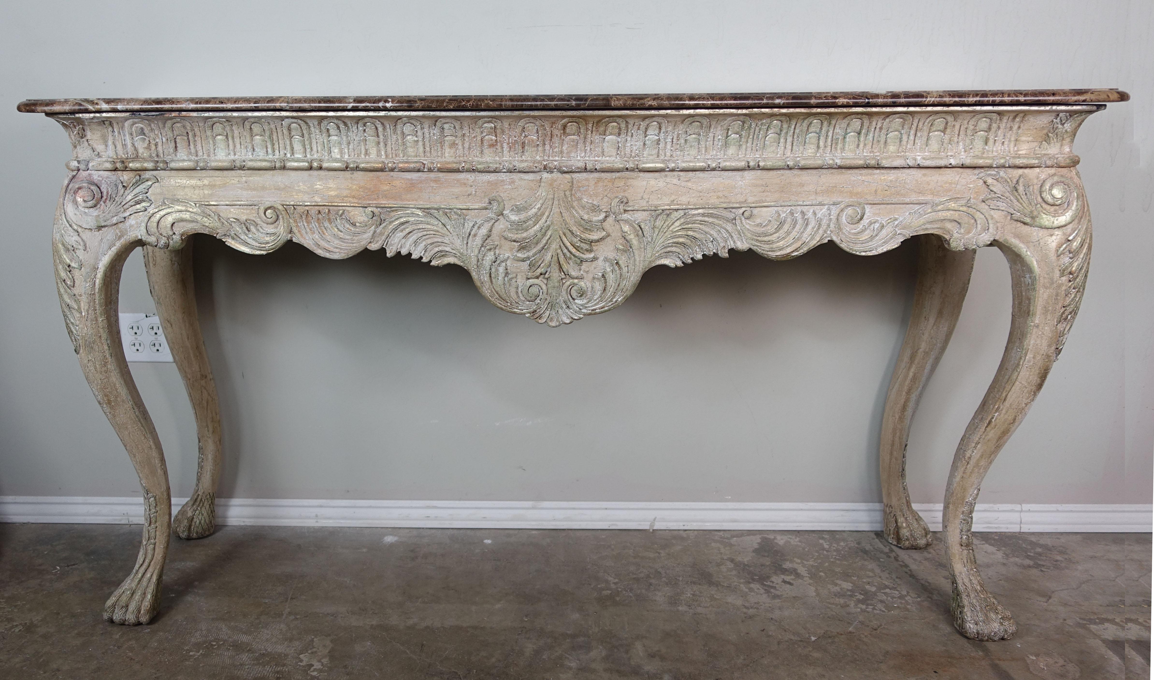French carved Louis XV style console standing on four cabriole legs ending in paw shaped feet. Beautiful worn 