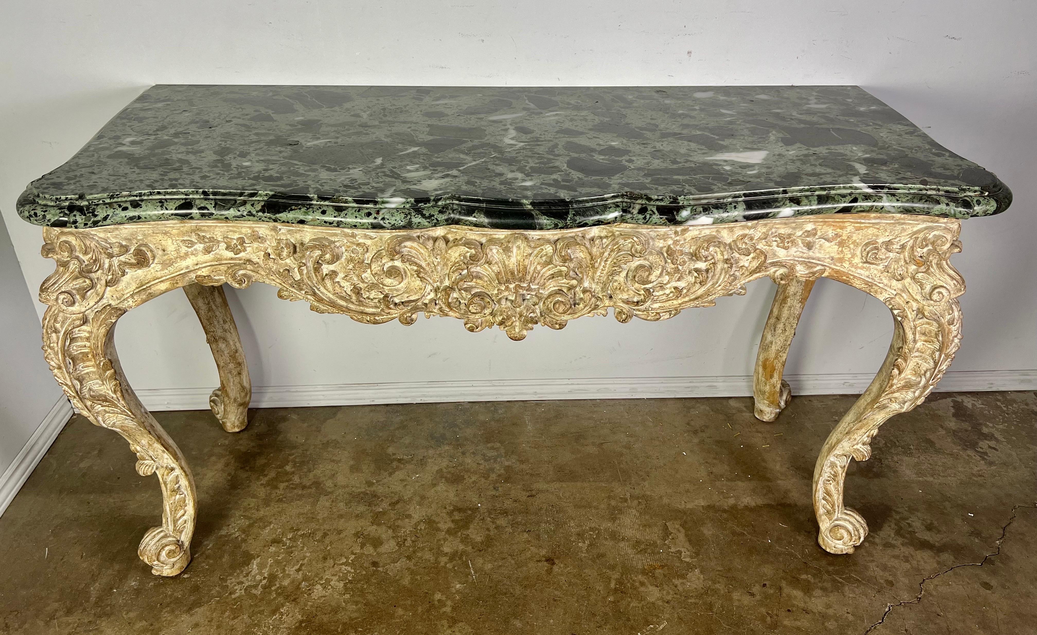 French carved Louis XV style console in a distressed painted finish. The marble top is 2
