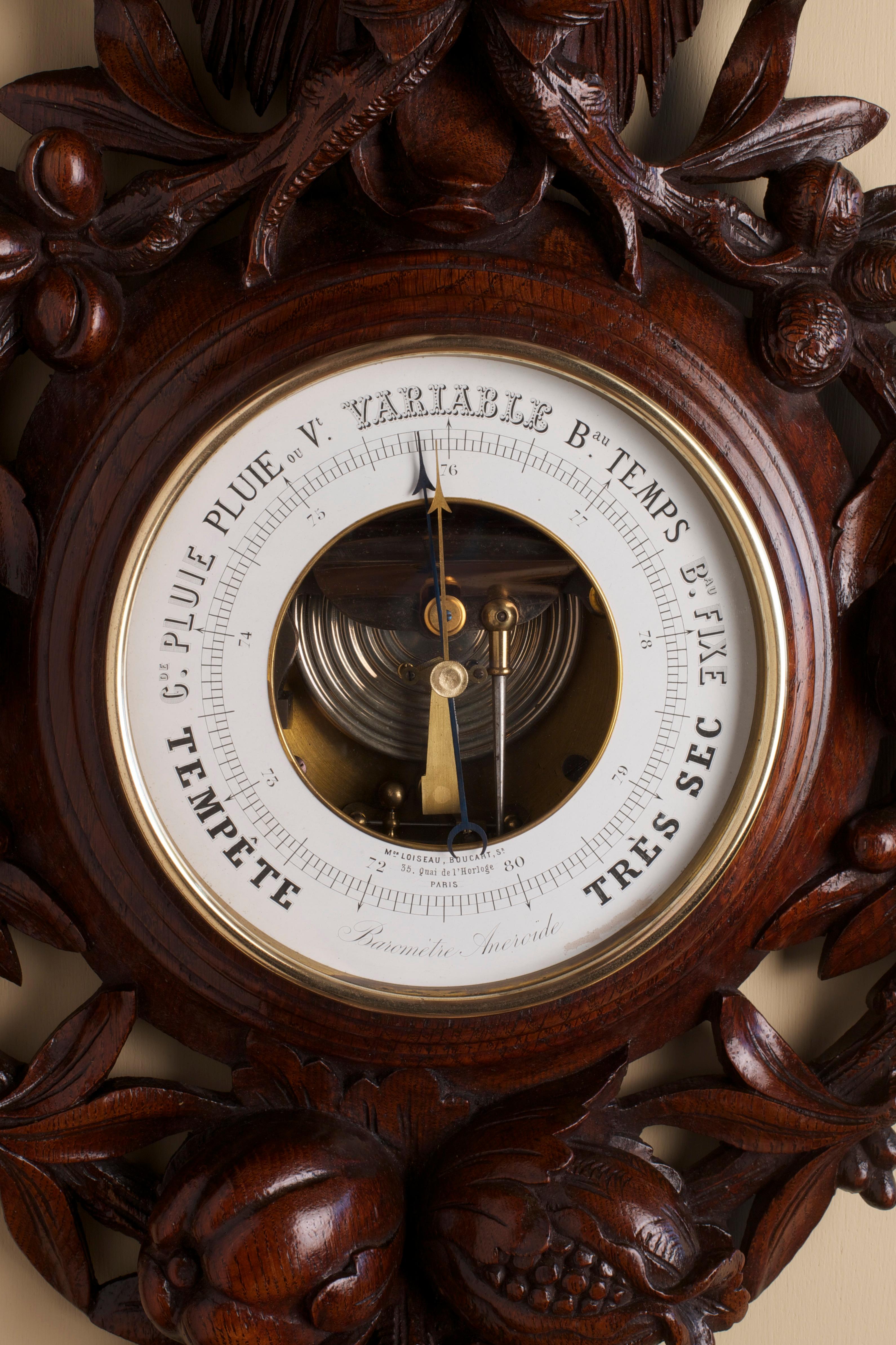 French wall barometer in a finely carved mahogany case with trailing fruit and vines surmounted by a lions mask, enamel dial with seven weather indications signed ‘Mon. Loiseau Boucart Sr., 35, Quai De L’Horloge, Paris’. Aneroid capsule movement
