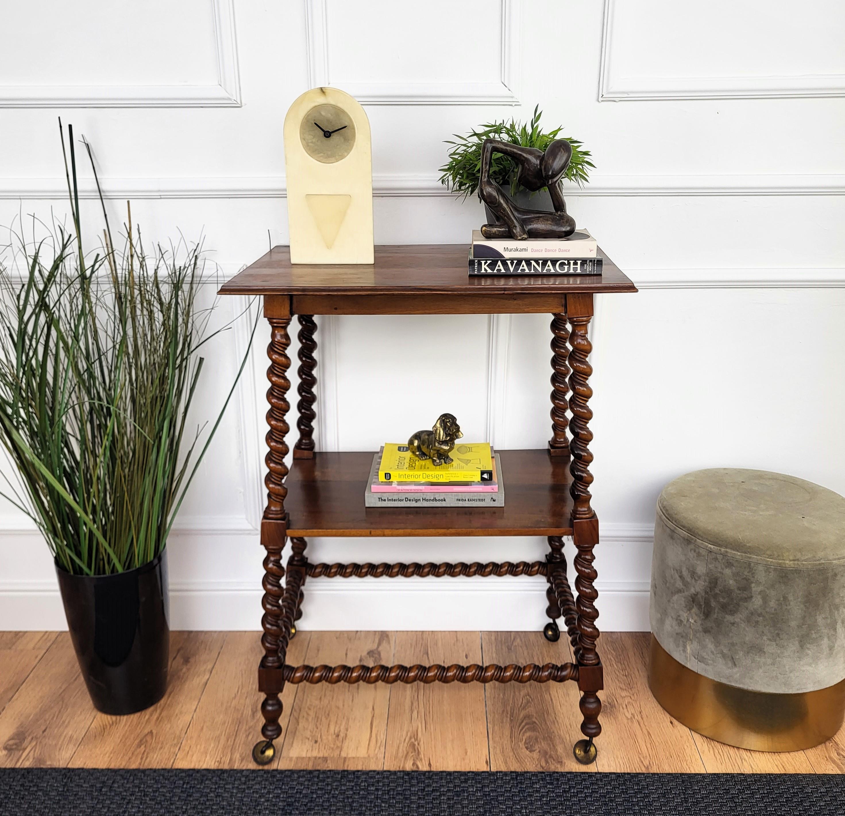 Beautiful antique French etagere, dry bar cart or side end table, characterized by the beveled edge table top, raised on four stunning Bobbin turned Barley twist carved legs, a central shelf and side stretchers, standing on four brass wheels.