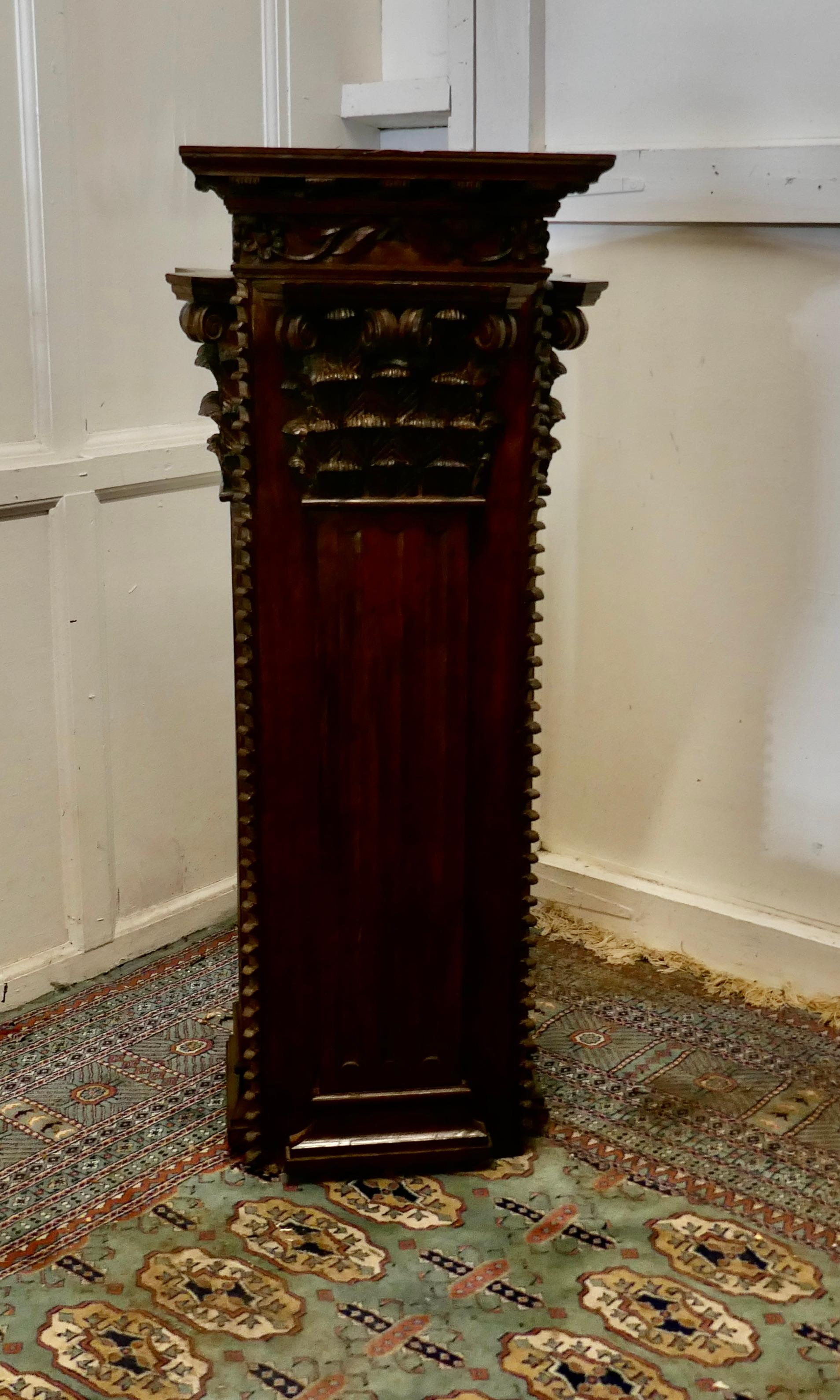 French carved oak column display pedestal 

The pedestal is square in shape, the top has a 14” x 17” plinth so it is ideal to display a large ornament or similar
The front and sides of the column have linenfold carving and nearer to the top they