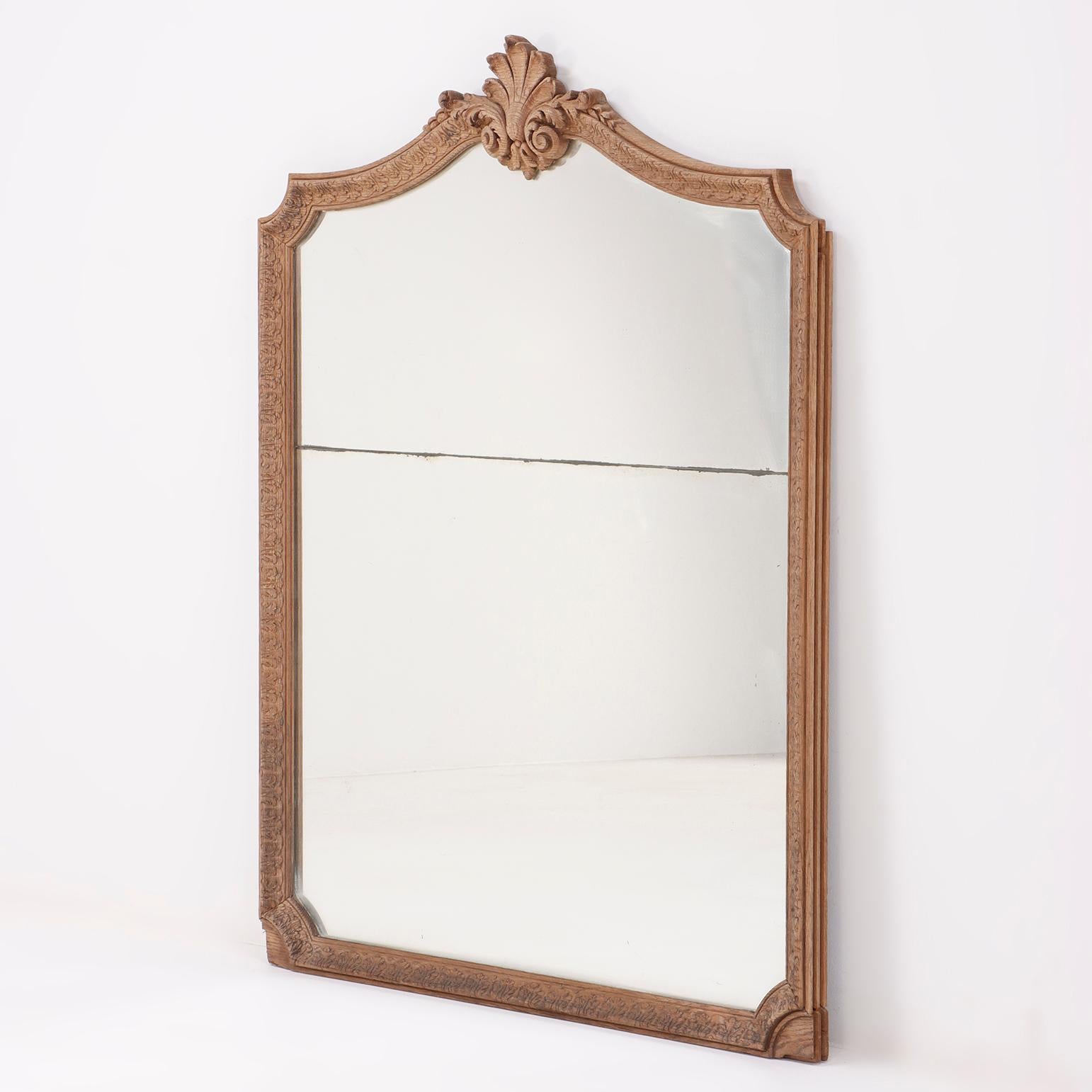 French carved oak mirror C 1800 having two plates of glass. This mirror appears to have been a part of a paneled room based on the design of the sides.