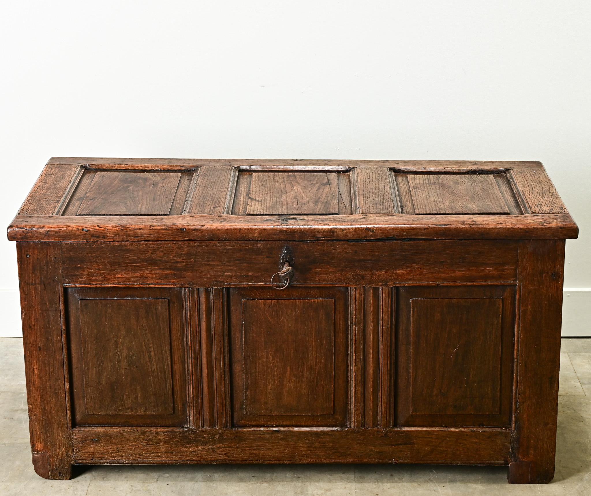 This French solid oak paneled coffer is from the 1800’s. The sturdy trunk opens on hand forged iron hinges with its original working lock and key. The interior is open and has a candle box on the top right side. Cleaned and polished with a French