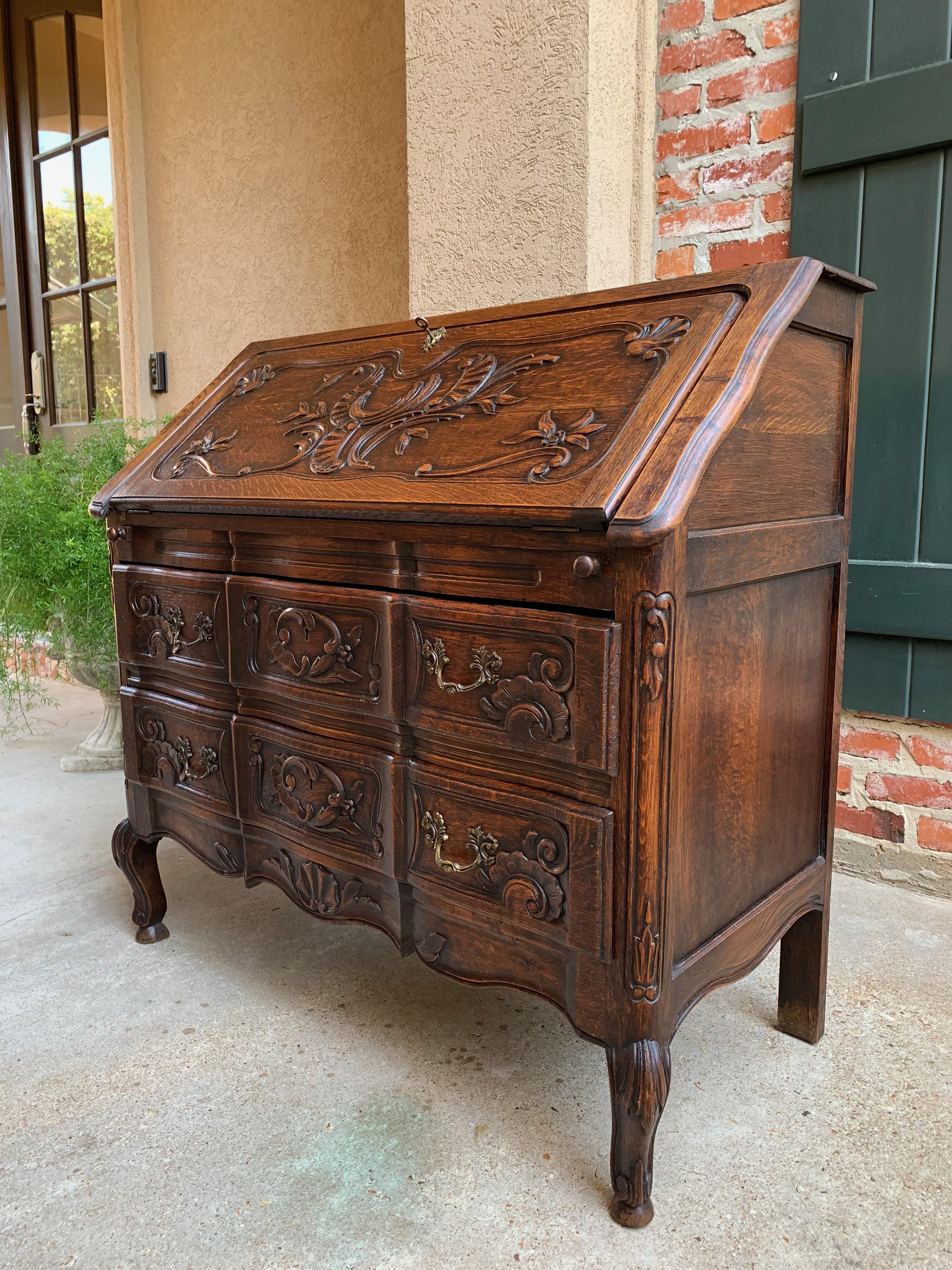 Direct from France, a lovely antique French carved “drop front” secretary/desk with quintessential French style from top to bottom!

~ Ornately carved French “drop front” or slant front has beautiful double beveled serpentine panel with elaborate