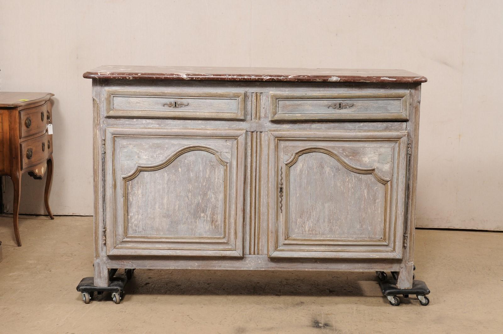 A French carved and painted wood buffet console, with original marble top, from the 19th century. This antique cabinet from France features the original marble top, rectangular in shaped with rounded front corners, atop the wooden case which houses