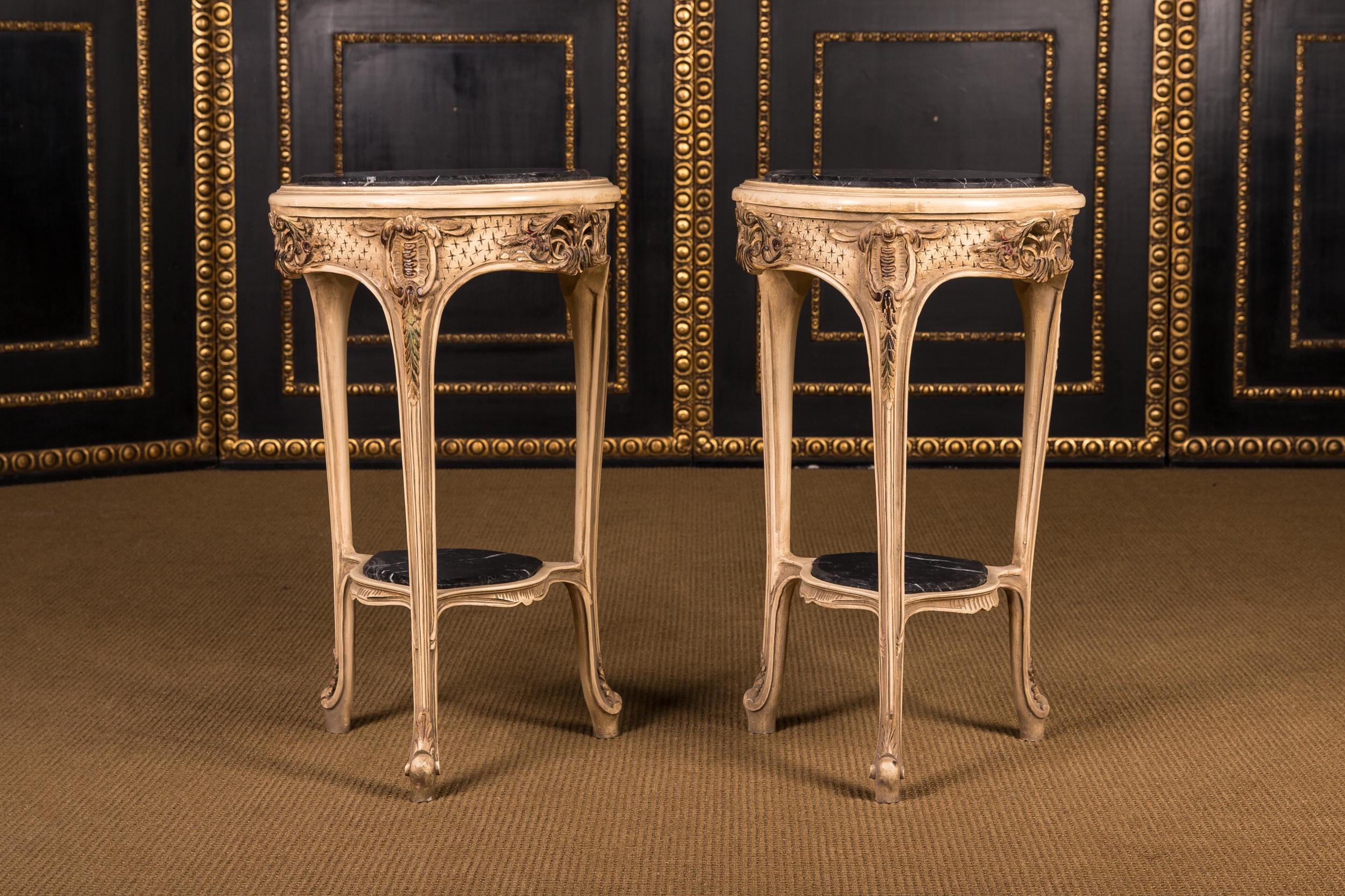 High quality solid beech wood finely carved down to the last detail. Colored and gilt gilded. Cambered, all-round ornamental relief base with carved foliage and openwork rocaille on curly legs. Below connected by a curly tray embedded in wickerwork.