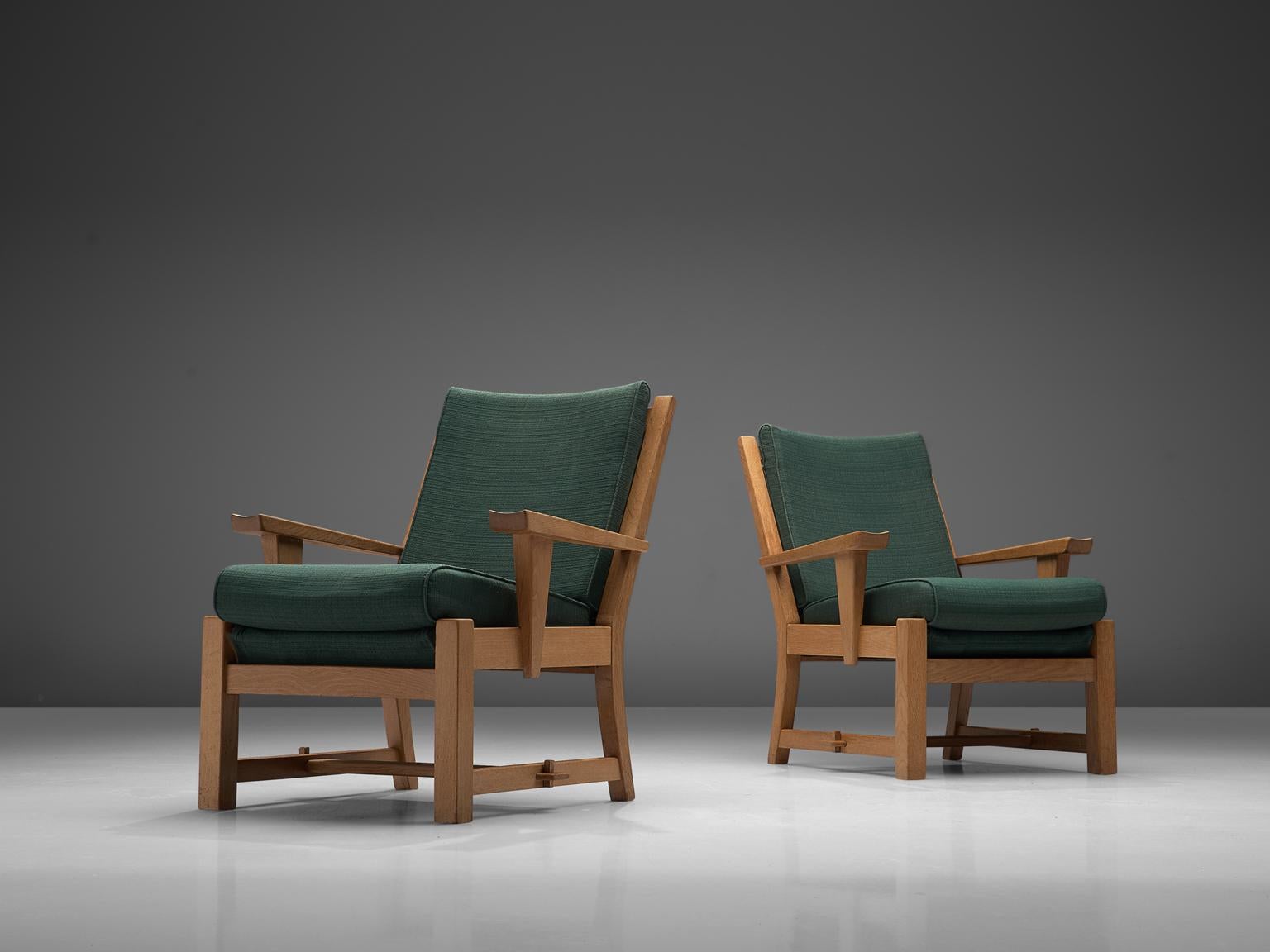 Pair of easy chairs, green fabric and oak, France, 1950s

These sculptural easy chairs are designed in France. They are of a high quality solid oak. These comfortable armchairs have an interesting open construction, with a slatted back. The