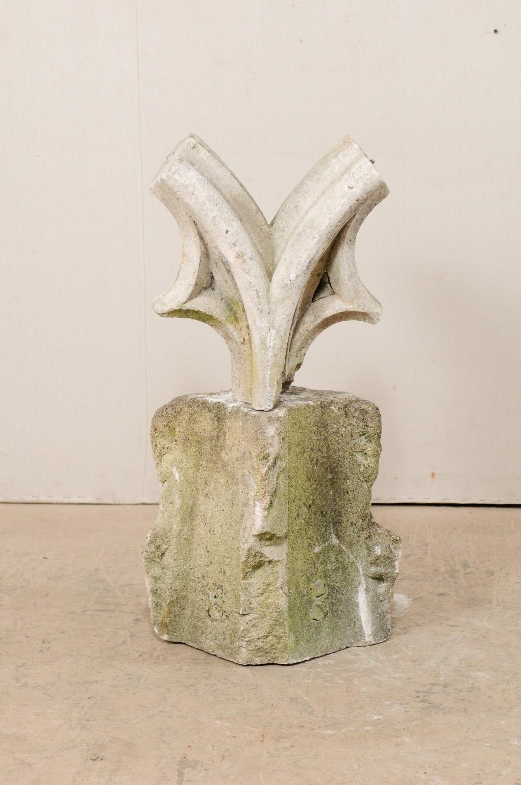 A French carved stone garden sculpture on pedestal from the 19th century, though potentially much older. This antique garden element from France features an abstract hand carved stone statue at top with deep v-Formations, which once was a part of a